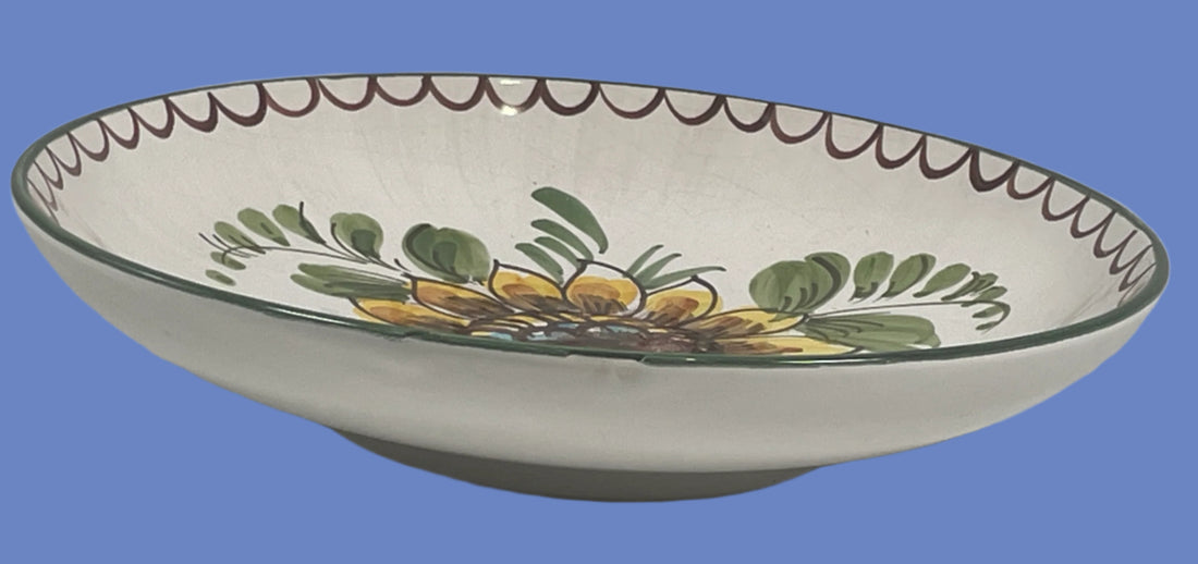 Decorative ceramic bowl with floral design on a white surface.
