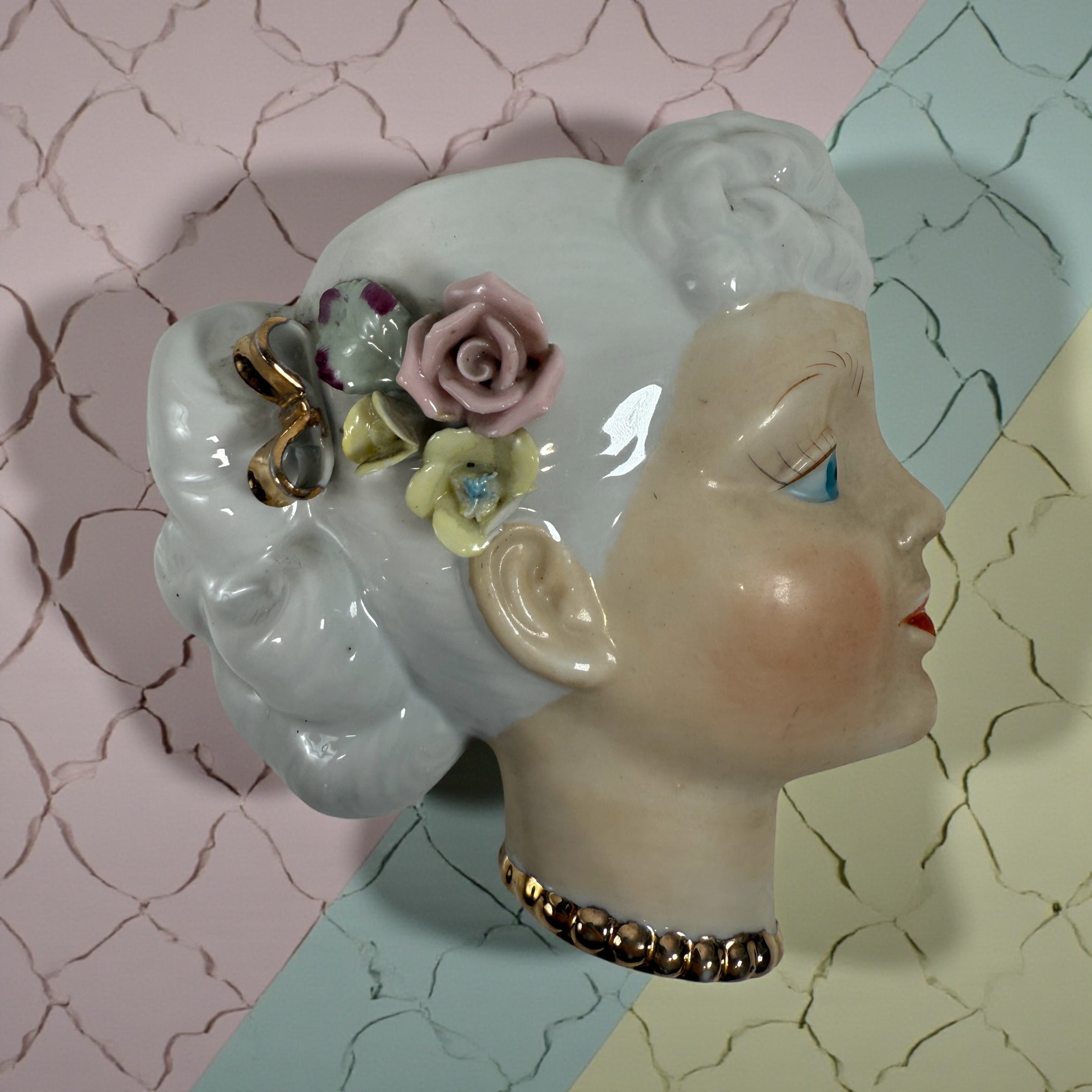 Mid-century Japanese porcelain lady-head wall mask with floral accents. Vintage décor piece with one chipped flower. Ideal for collectors and retro interiors.