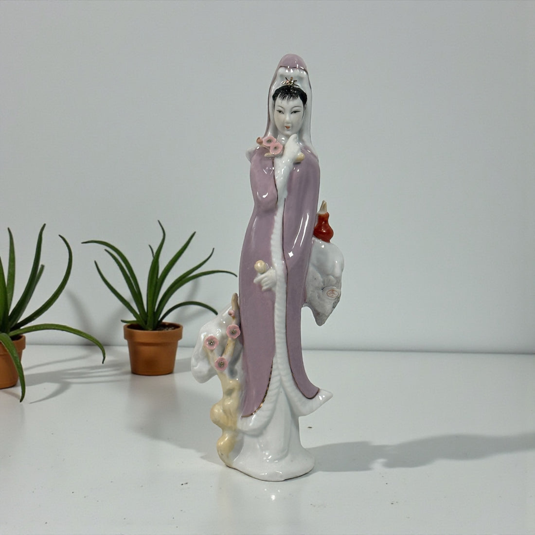 Vintage Chinese export Guanyin porcelain figurine with pastel lavender robe. Mid-century Buddhist decor, serene and elegant, in very good condition.