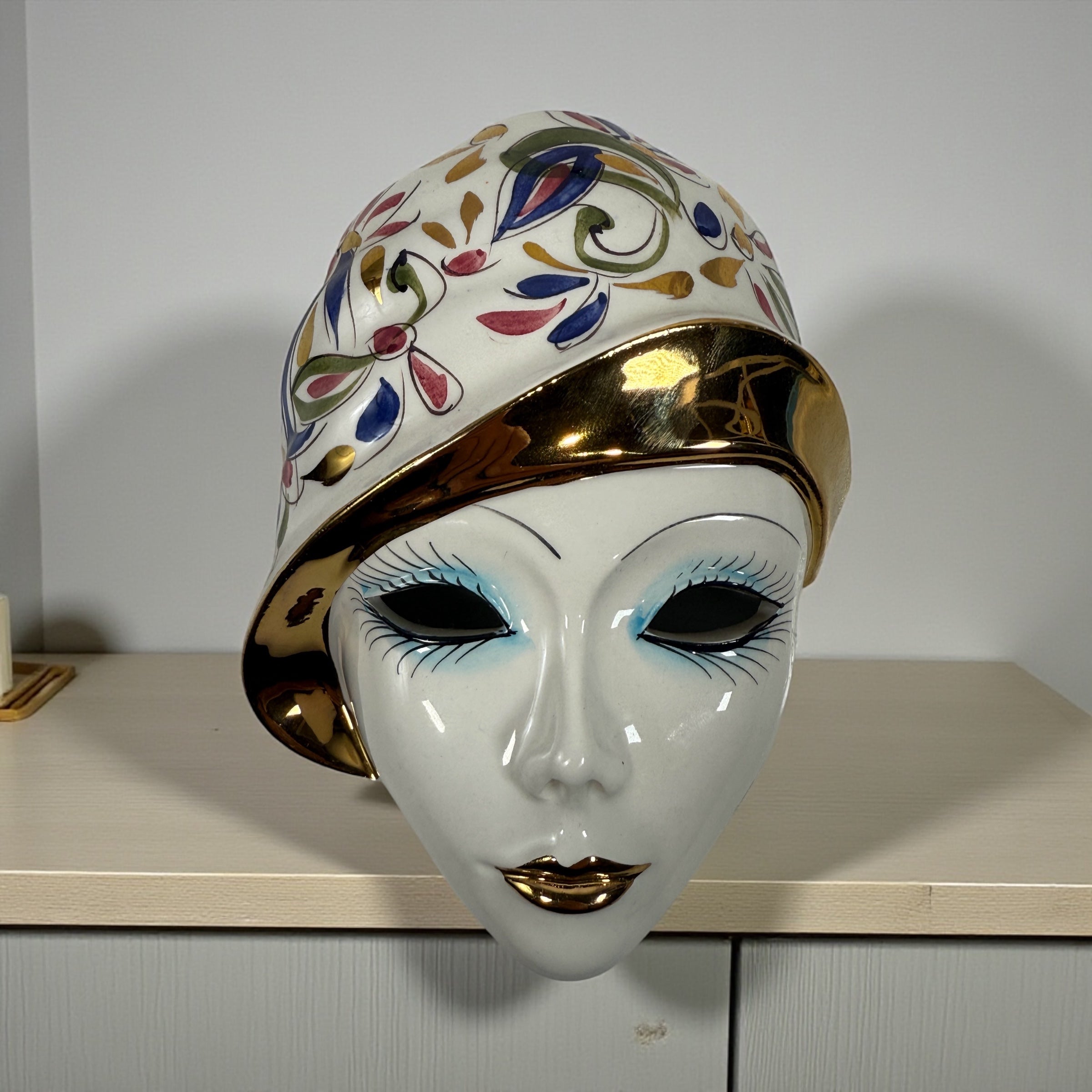 Vintage Italian ceramic wall mask from Modena with hand-painted floral design and gold accents. Authentic mid-century wall décor made in Italy.