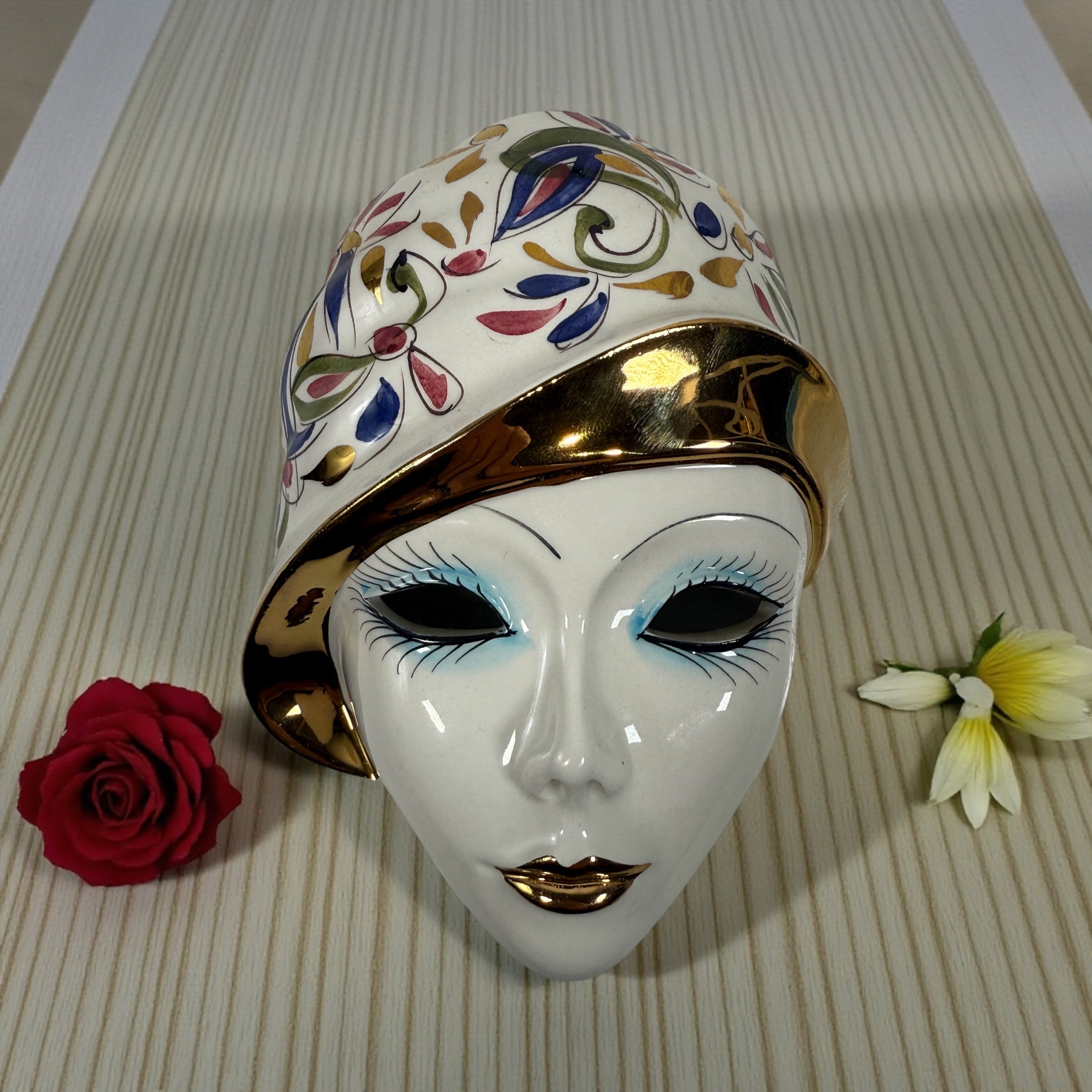 Vintage Italian ceramic wall mask from Modena with hand-painted floral design and gold accents. Authentic mid-century wall décor made in Italy.