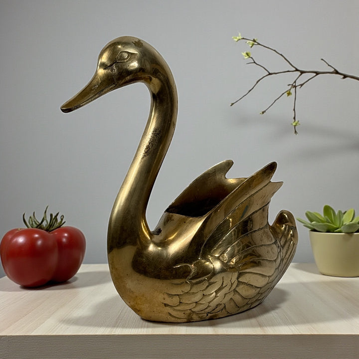 Vintage solid brass swan planter made in Korea with engraved feather detail and aged patina. Decorative centerpiece or planter for classic interiors.