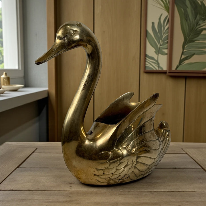 Vintage solid brass swan planter made in Korea with engraved feather detail and aged patina. Decorative centerpiece or planter for classic interiors.