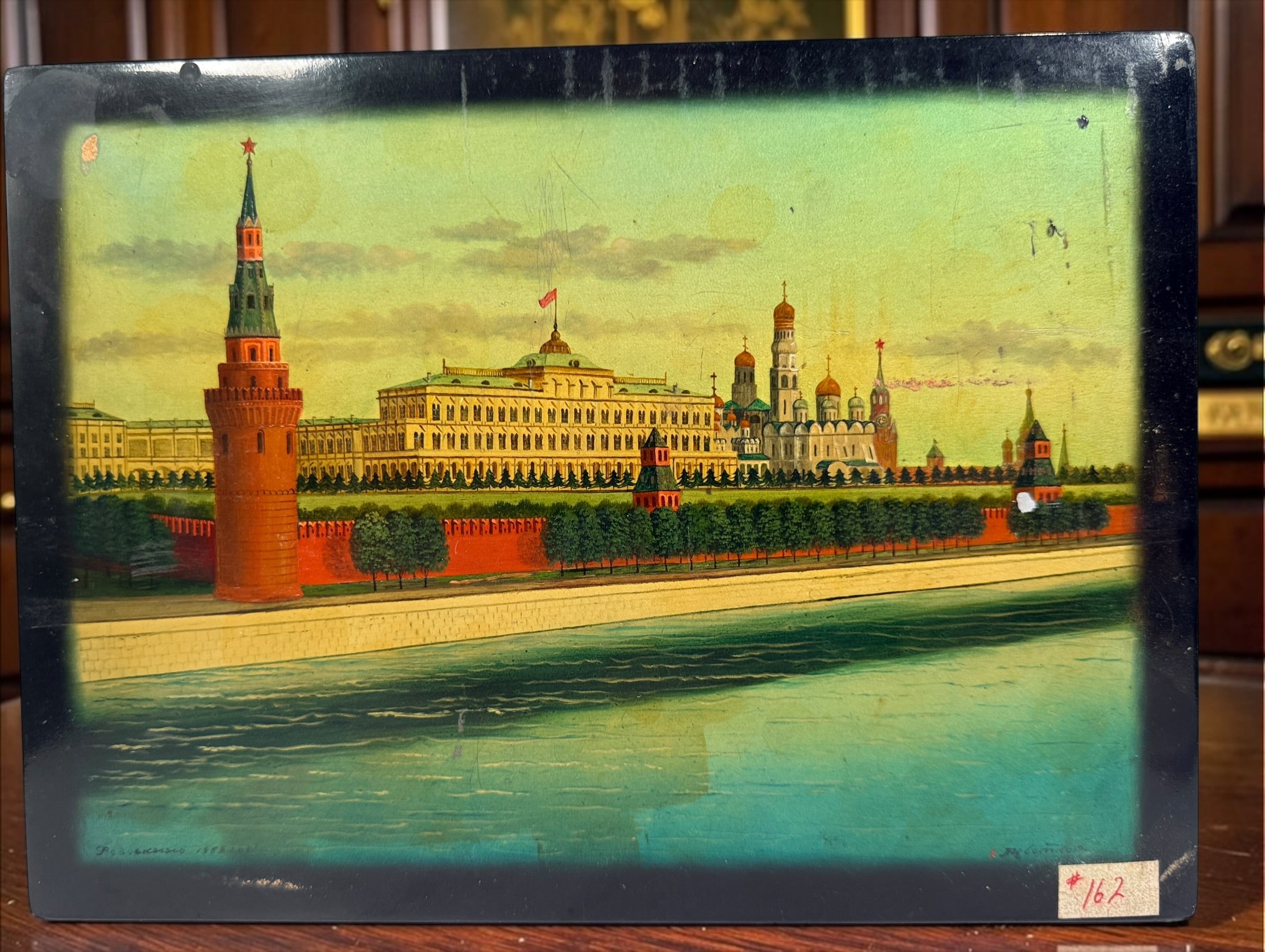 Vintage Russian lacquer decorative box featuring a historic Moscow Kremlin scene, black lacquer exterior and striking red interior