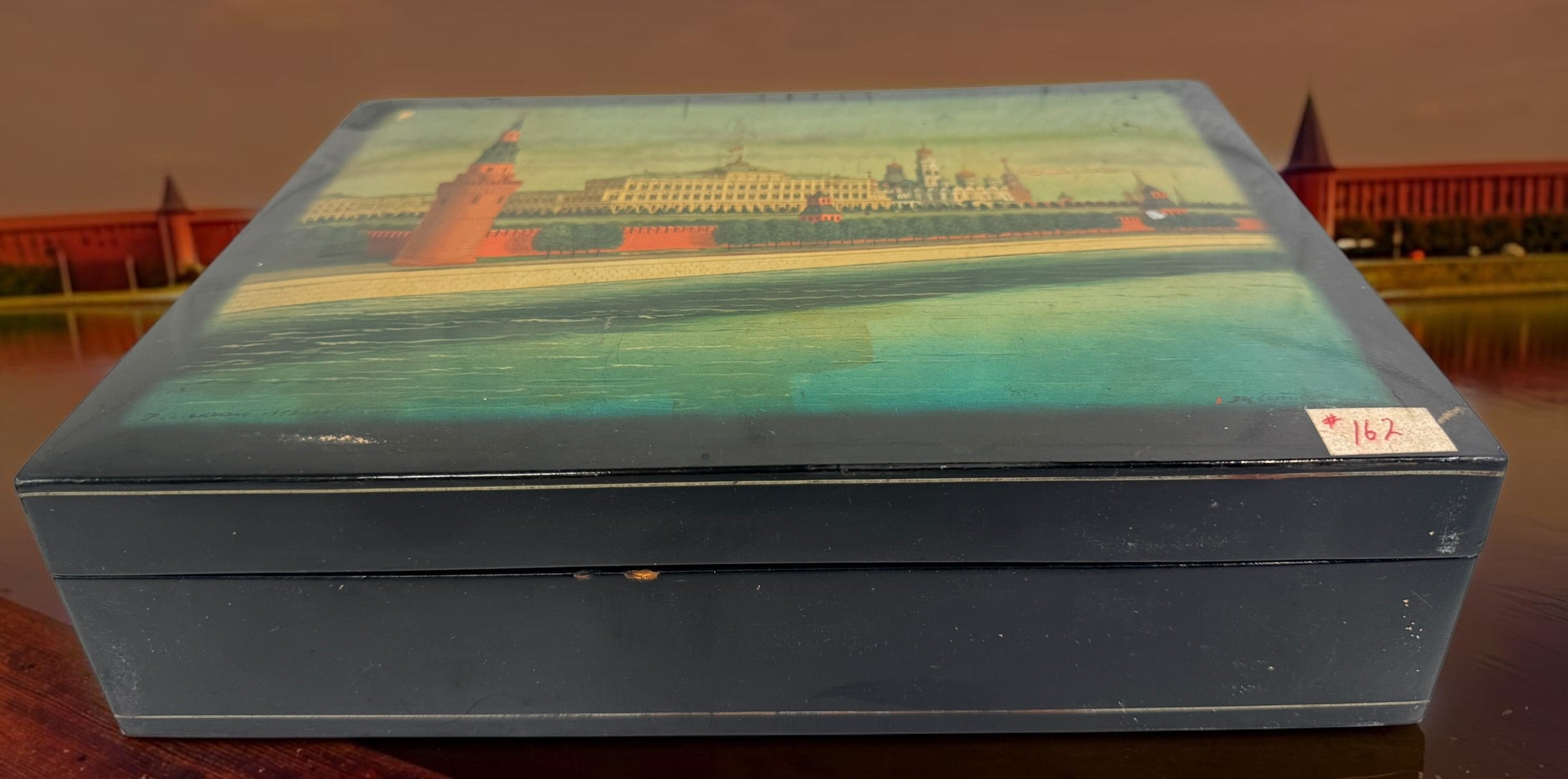 Vintage Russian lacquer decorative box featuring a historic Moscow Kremlin scene, black lacquer exterior and striking red interio