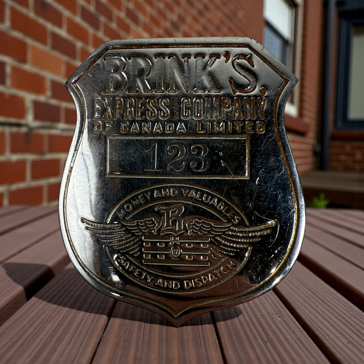 Vintage Brink’s Express Company of Canada security badge No. 123 from the 1940s. Authentic Canadian armored transport employee badge with original patina.