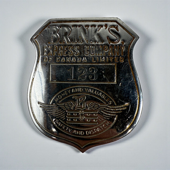 Vintage Brink’s Express Company of Canada security badge No. 123 from the 1940s. Authentic Canadian armored transport employee badge with original patina.