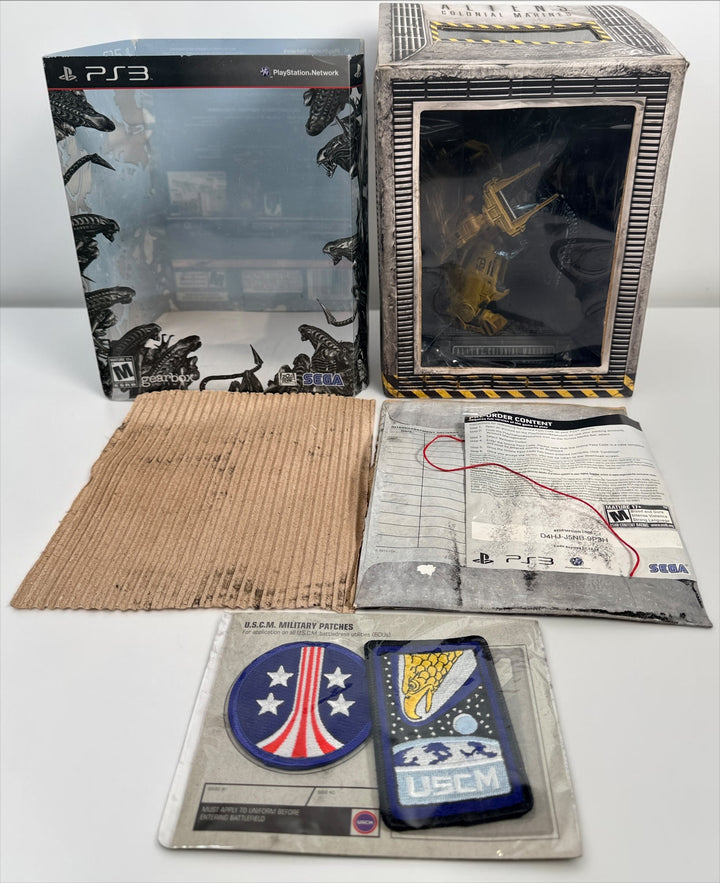 Aliens Colonial Marines Collector’s Edition for PS3 with Power Loader vs. Xenomorph statue, sealed USCM patches and original packaging. Water-damaged box.