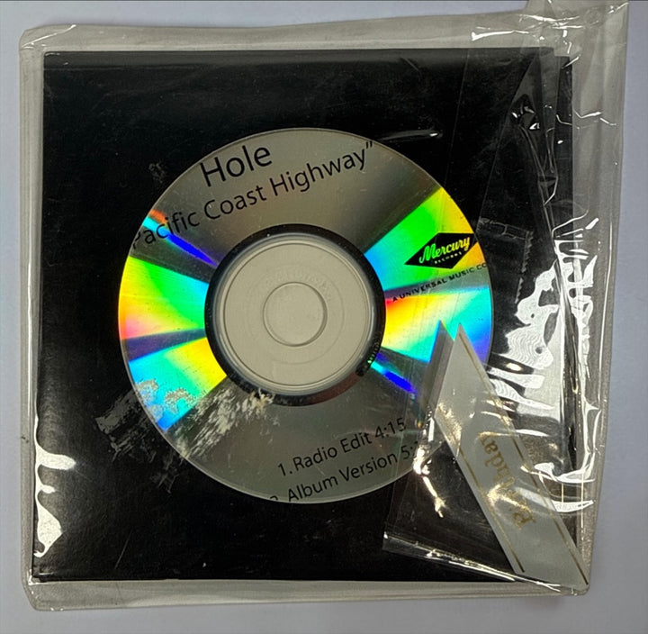 Official 2010 Hole Mercury Records promotional CD lot featuring Pacific Coast Highway and Skinny Little Bitch. Includes two original radio promo CDs in paper sleeves.