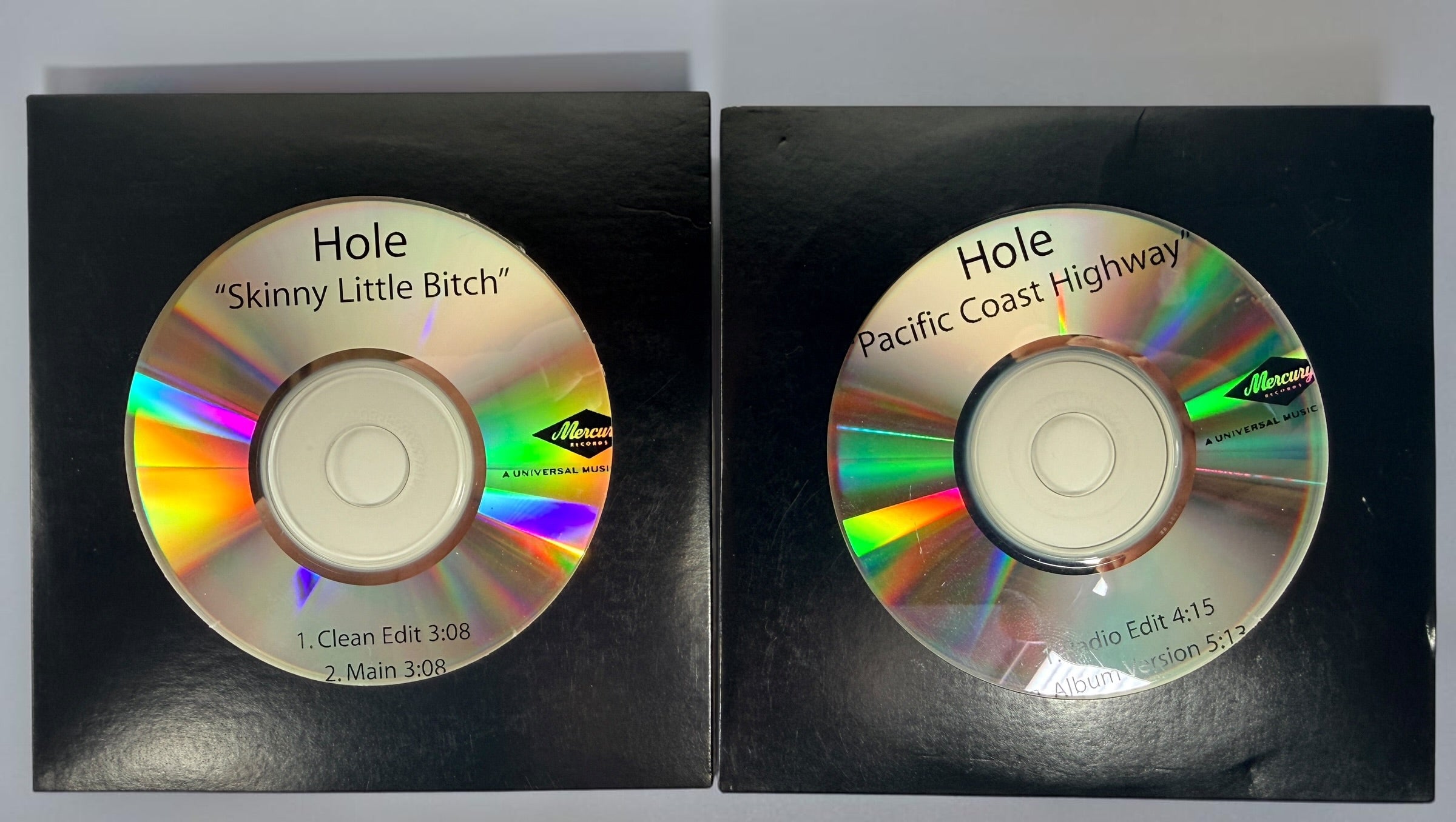 Official 2010 Hole Mercury Records promotional CD lot featuring Pacific Coast Highway and Skinny Little Bitch. Includes two original radio promo CDs in paper sleeves.