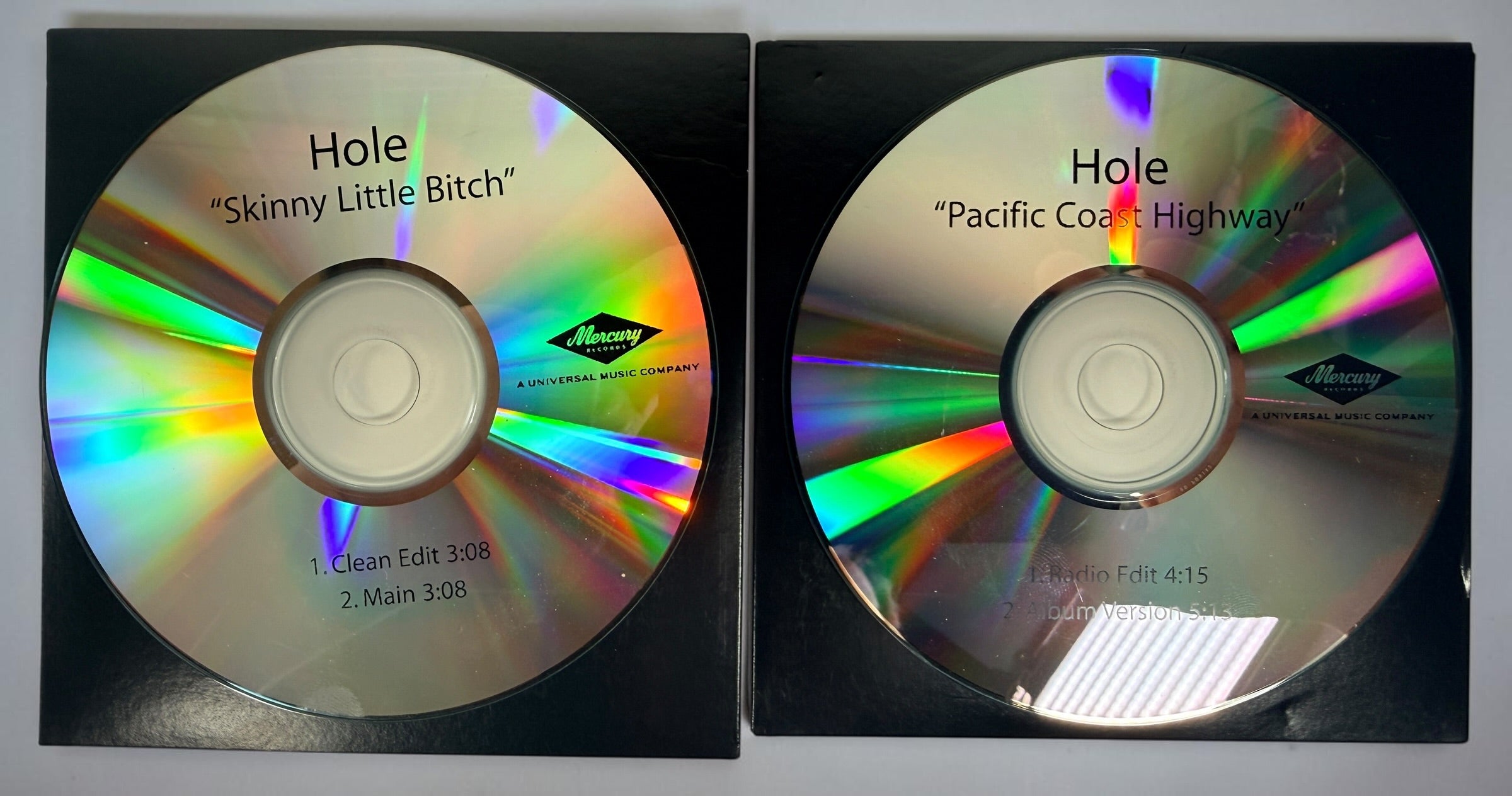 Official 2010 Hole Mercury Records promotional CD lot featuring Pacific Coast Highway and Skinny Little Bitch. Includes two original radio promo CDs in paper sleeves.