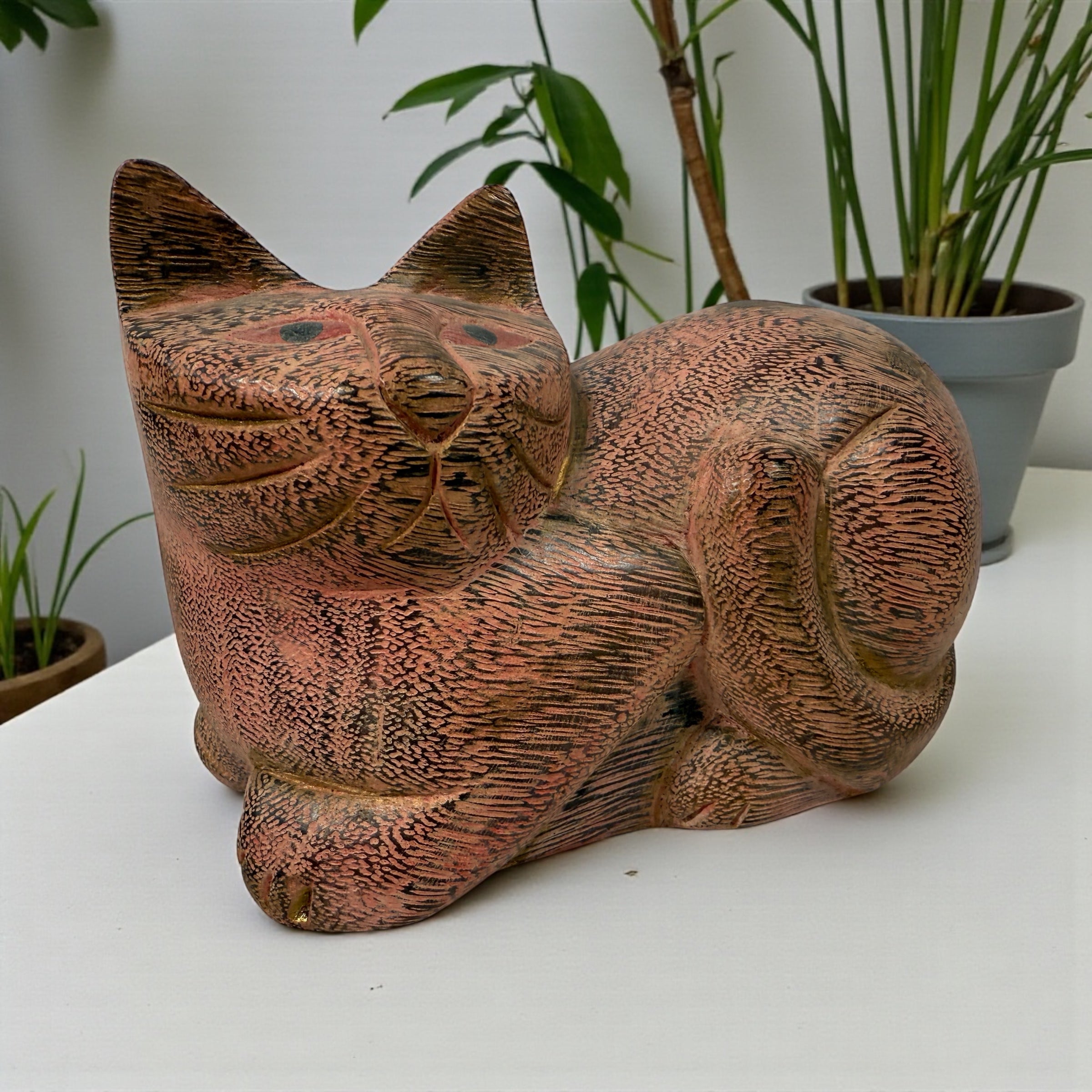 Hand-carved wooden cat sculpture in folk art style. Solid wood, decorative carved texture, warm natural finish. Unique décor piece for cat lovers.