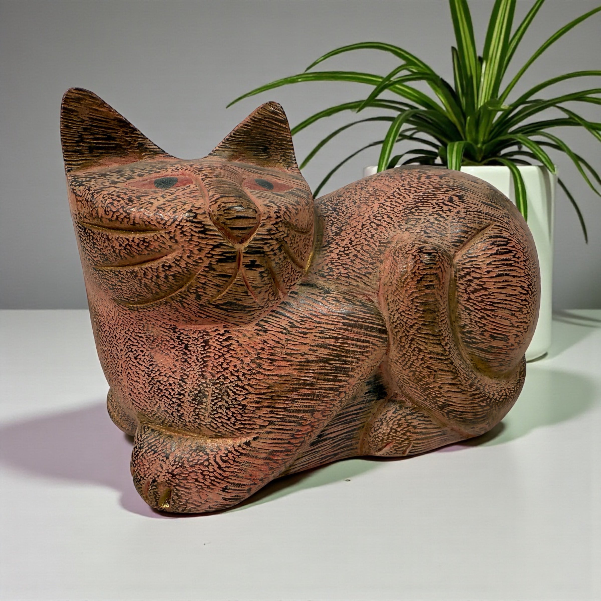Hand-carved wooden cat sculpture in folk art style. Solid wood, decorative carved texture, warm natural finish. Unique décor piece for cat lovers.