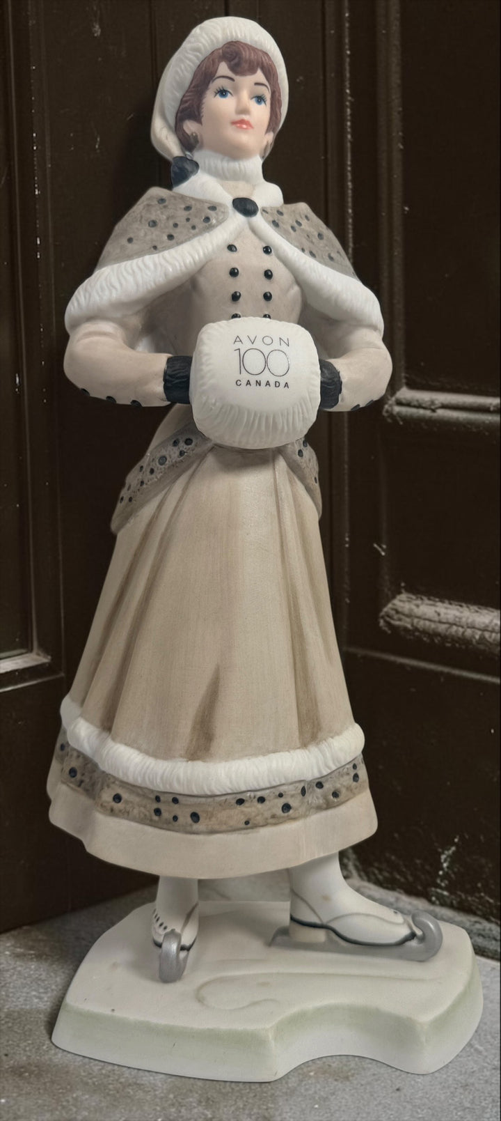 Exclusive Avon Canada 100th anniversary Mrs. P.F.E. Albee figurine award from 2014–2015 featuring a winter skating theme and original commemorative inscription.