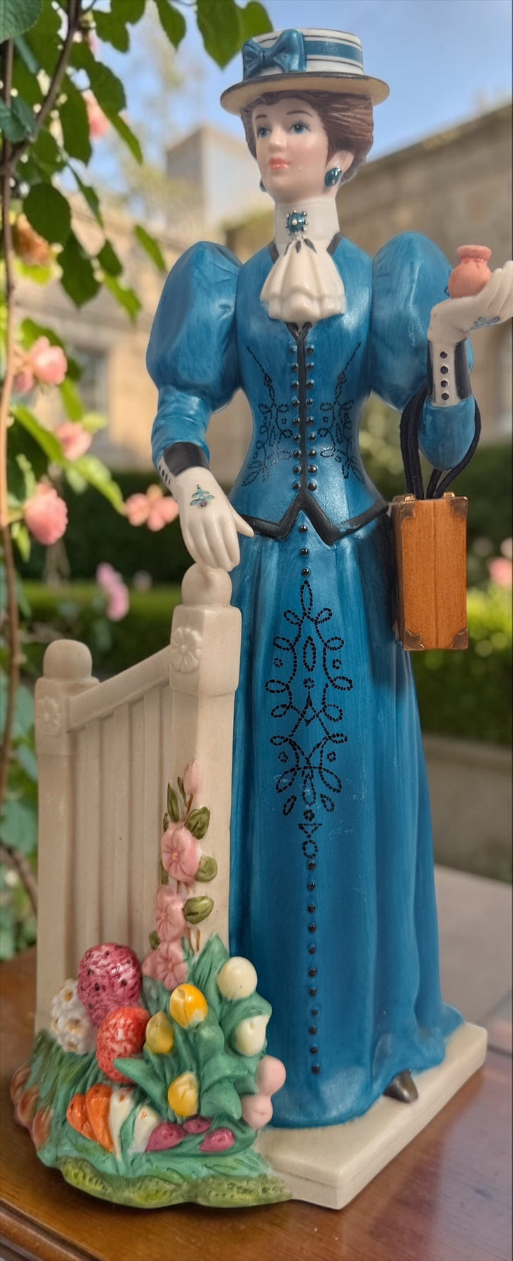 Avon Canada Mrs. Albee President’s Club ceramic figurine from 2009–2010, featuring a Victorian lady in a blue dress with hand-painted details and original inscription.