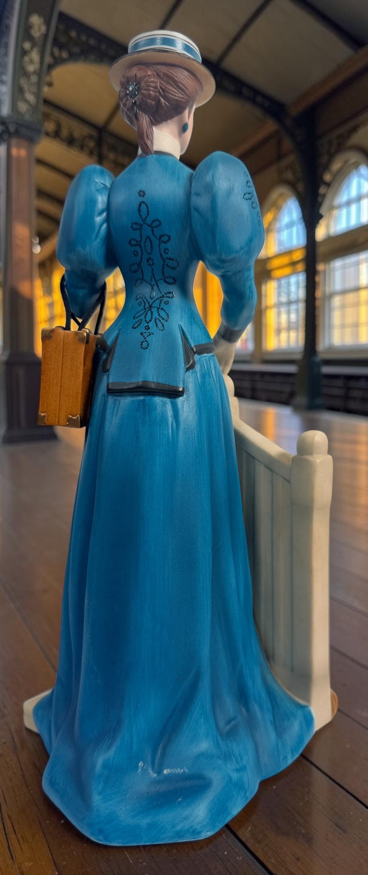 Avon Canada Mrs. Albee President’s Club ceramic figurine from 2009–2010, featuring a Victorian lady in a blue dress with hand-painted details and original inscription.