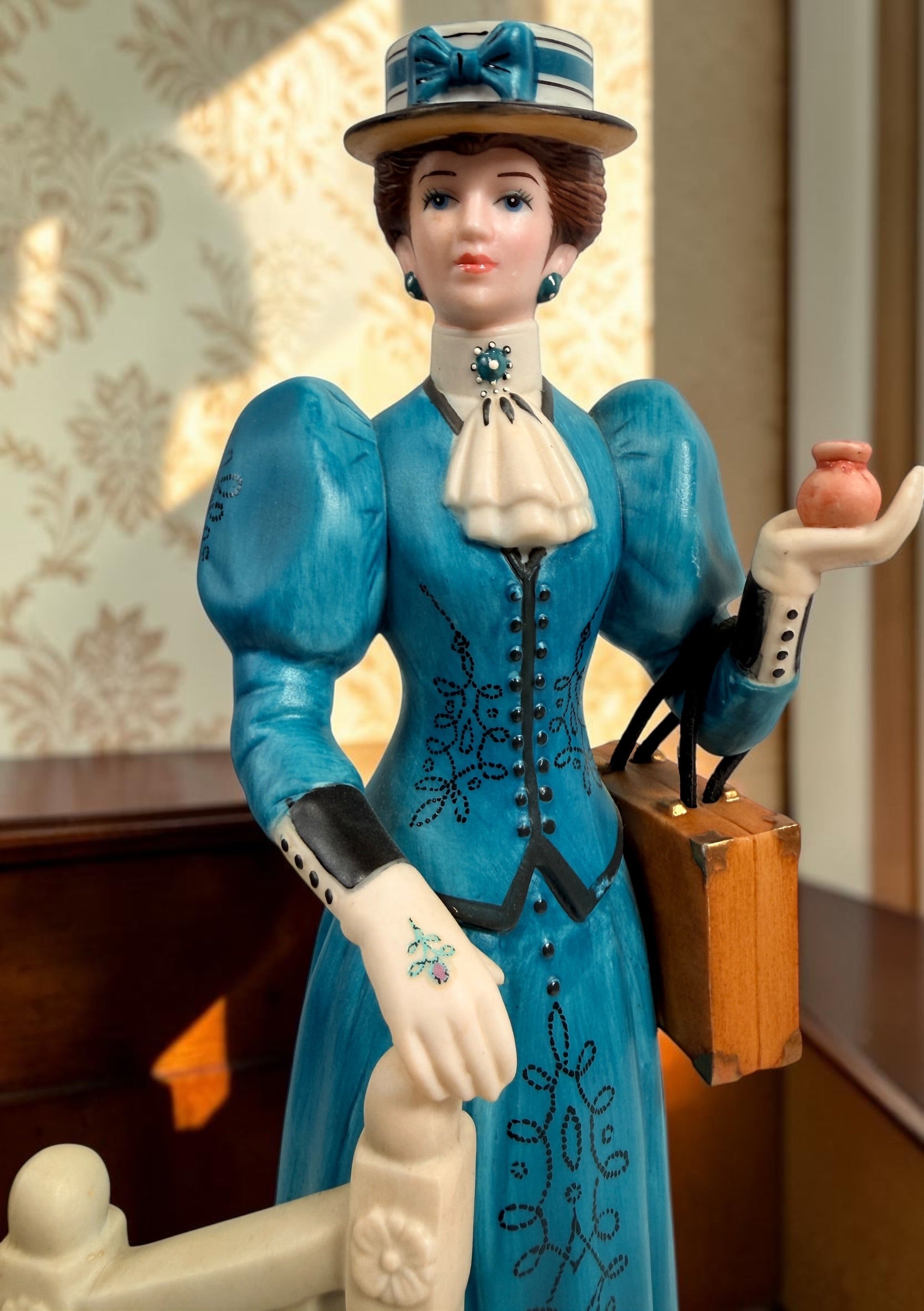 Avon Canada Mrs. Albee President’s Club ceramic figurine from 2009–2010, featuring a Victorian lady in a blue dress with hand-painted details and original inscription.