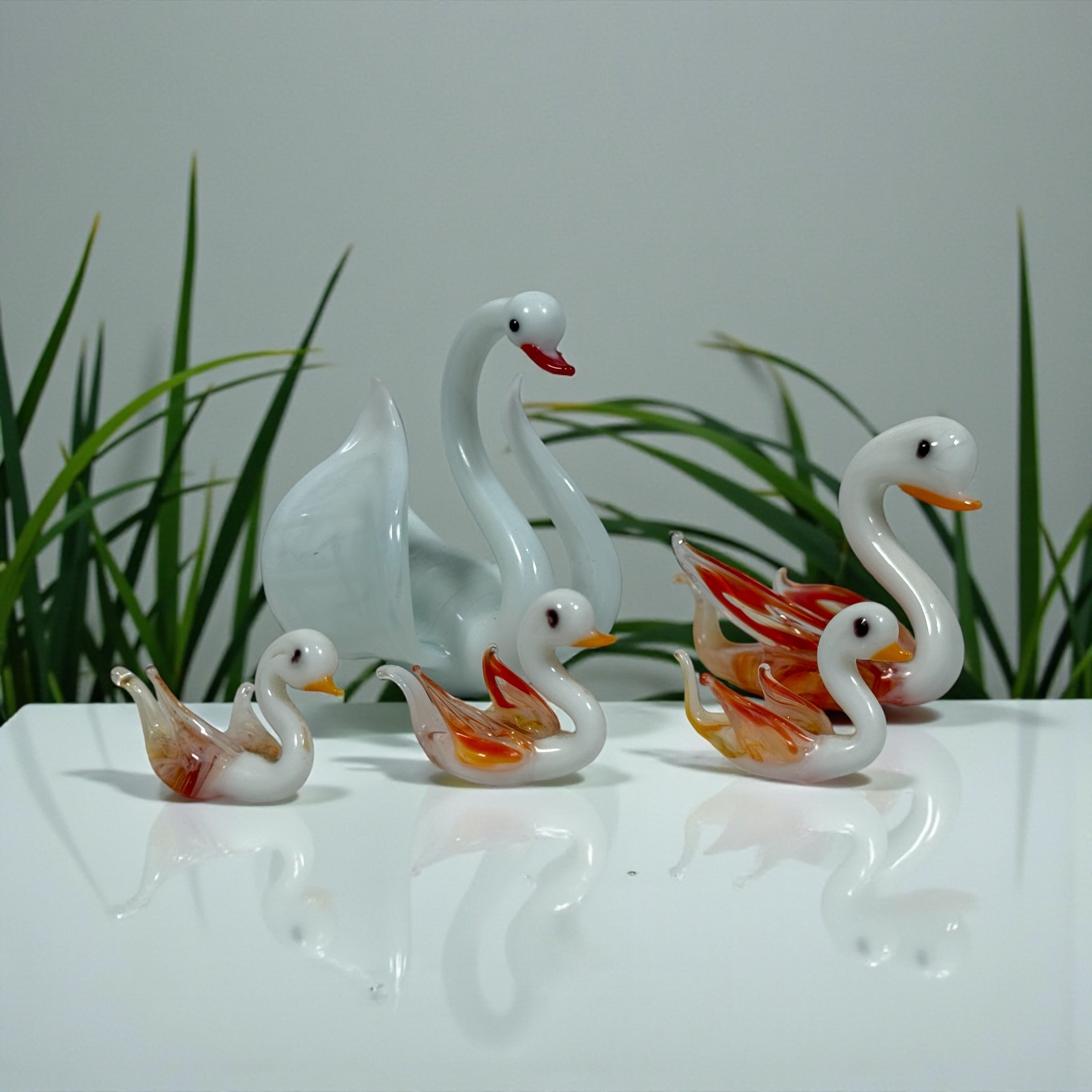 Murano-style art glass swan family set with opaline bodies and amber wings. Decorative 5-piece vintage-style glass display.