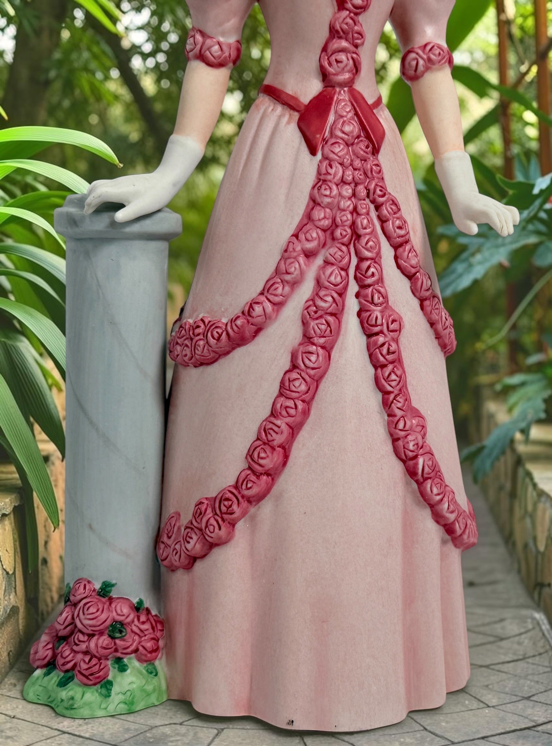2015 Mrs. Albee Avon commemorative figurine featuring a Victorian lady in a pink rose-trimmed dress with marble-look column. Ceramic collectible award statue.