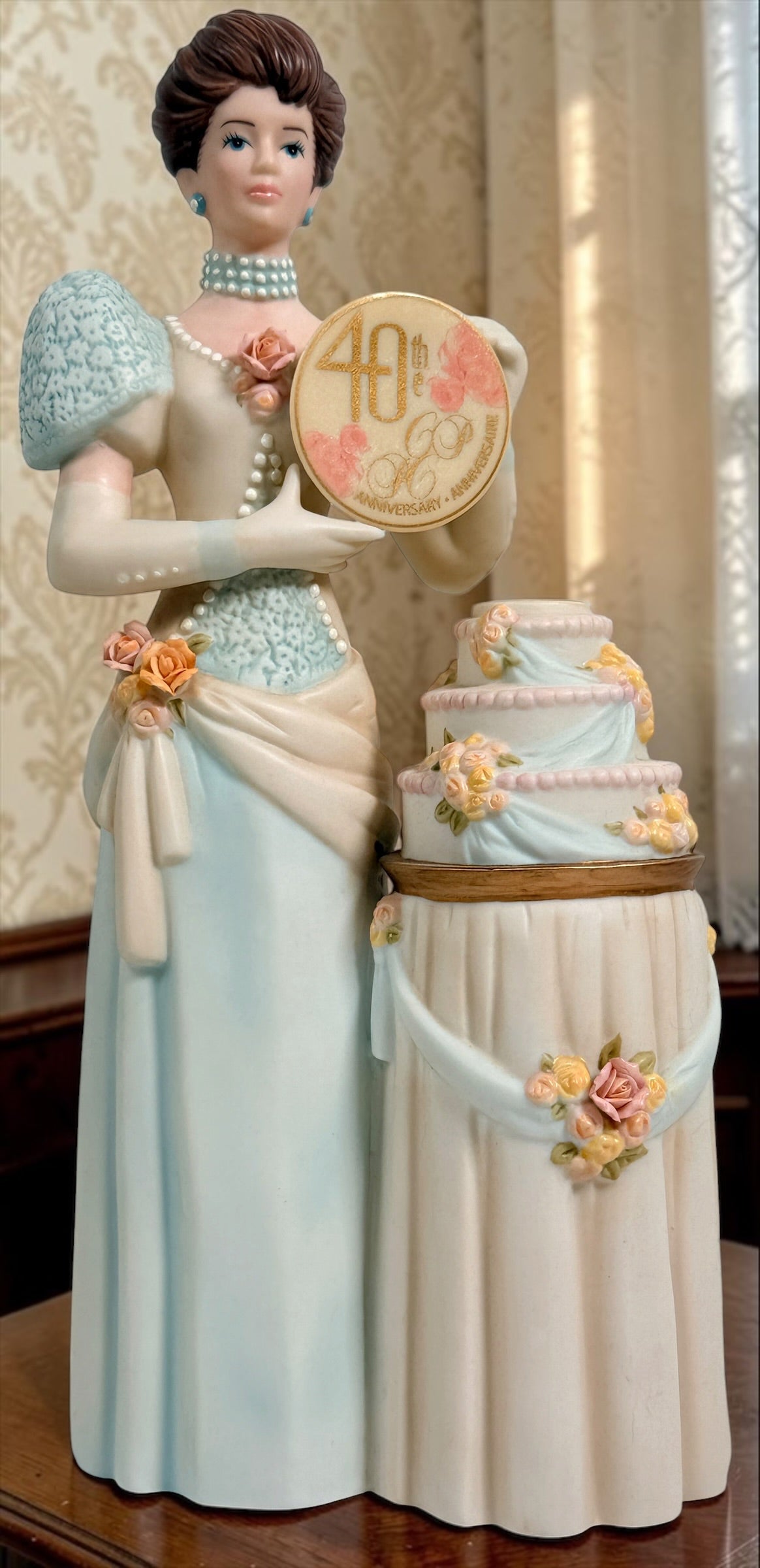 Avon Canada President’s Club 40th Anniversary commemorative figurine from 2007–2008 featuring an elegant lady and floral wedding cake display.