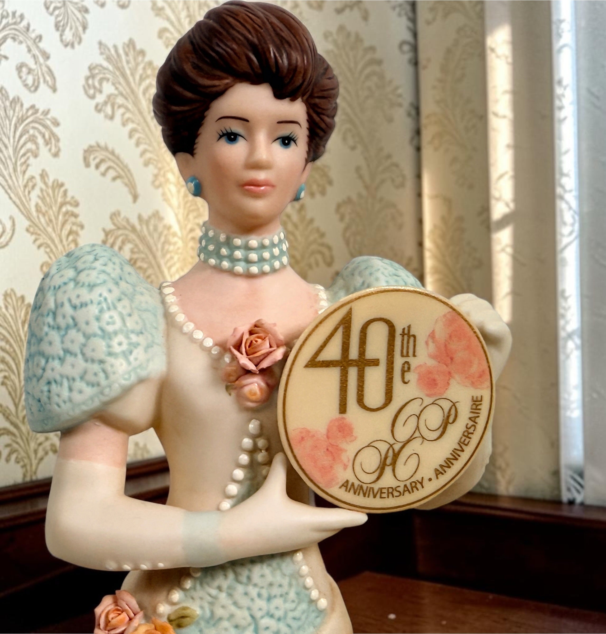 Avon Canada President’s Club 40th Anniversary commemorative figurine from 2007–2008 featuring an elegant lady and floral wedding cake display.