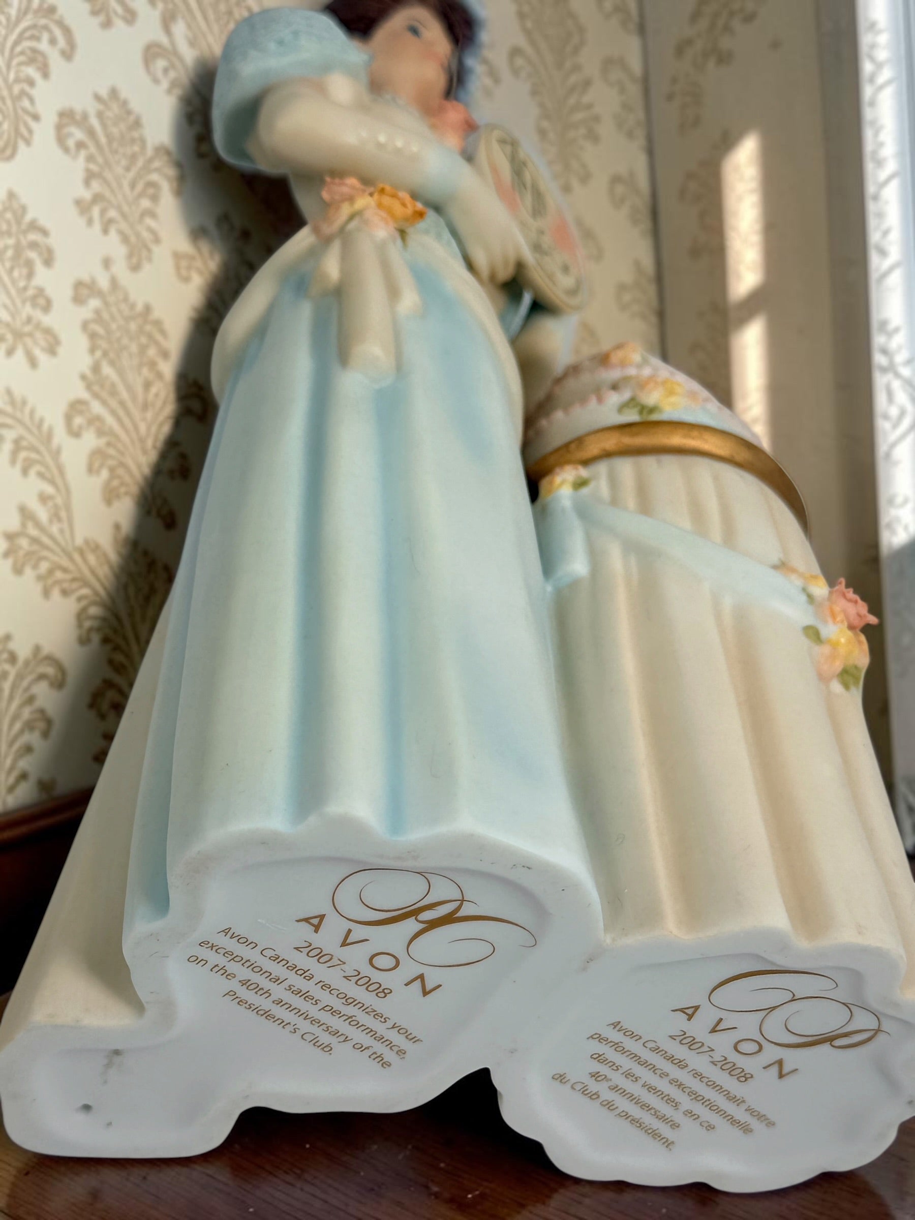 Avon Canada President’s Club 40th Anniversary commemorative figurine from 2007–2008 featuring an elegant lady and floral wedding cake display.