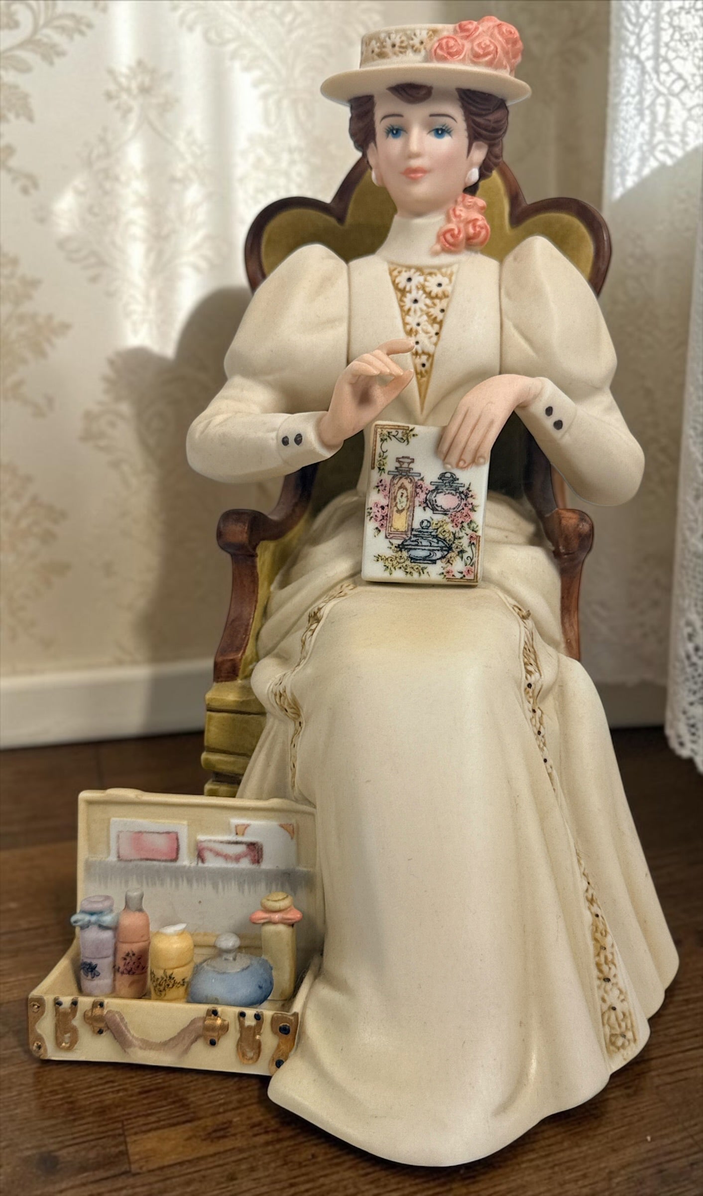 Official Avon Mrs. Albee Award figurine from 2011–2012 featuring Victorian styling, miniature cosmetics accessories, and bilingual commemorative inscription.
