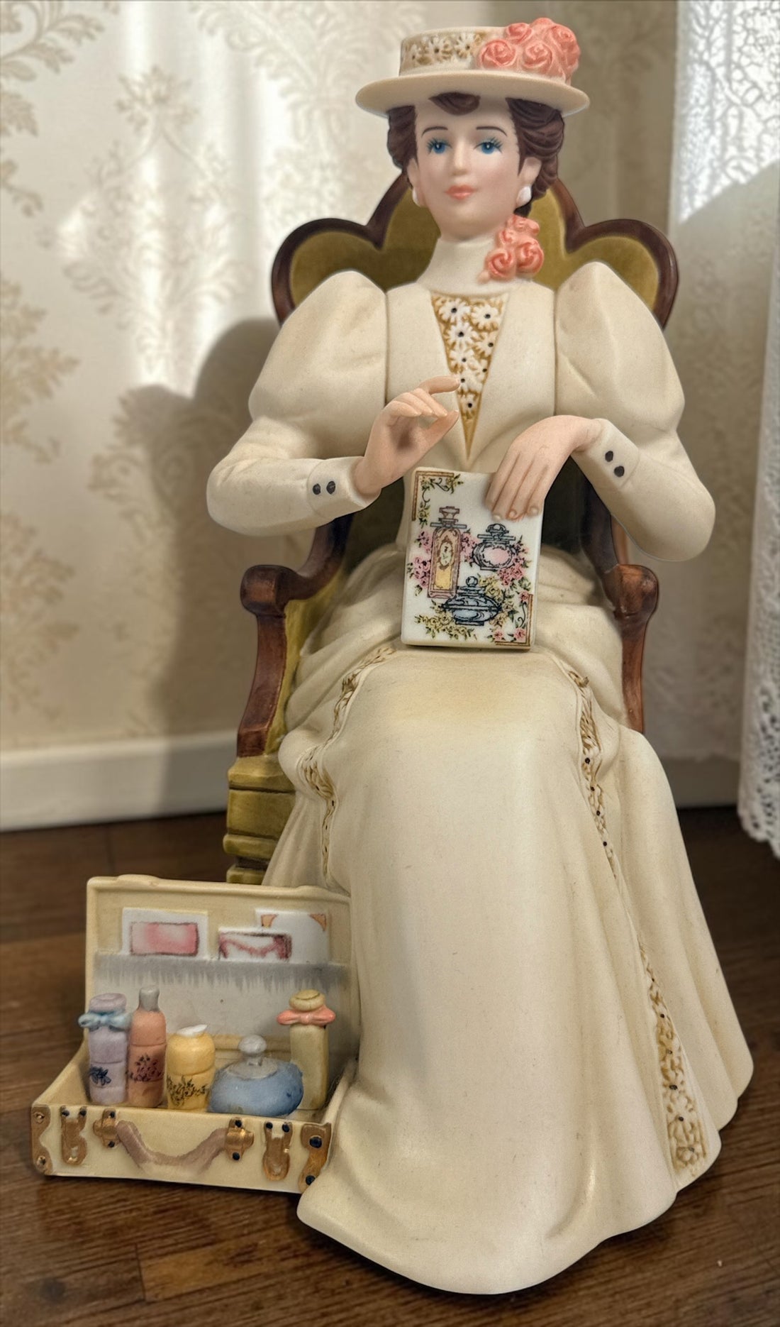 Official Avon Mrs. Albee Award figurine from 2011–2012 featuring Victorian styling, miniature cosmetics accessories, and bilingual commemorative inscription.