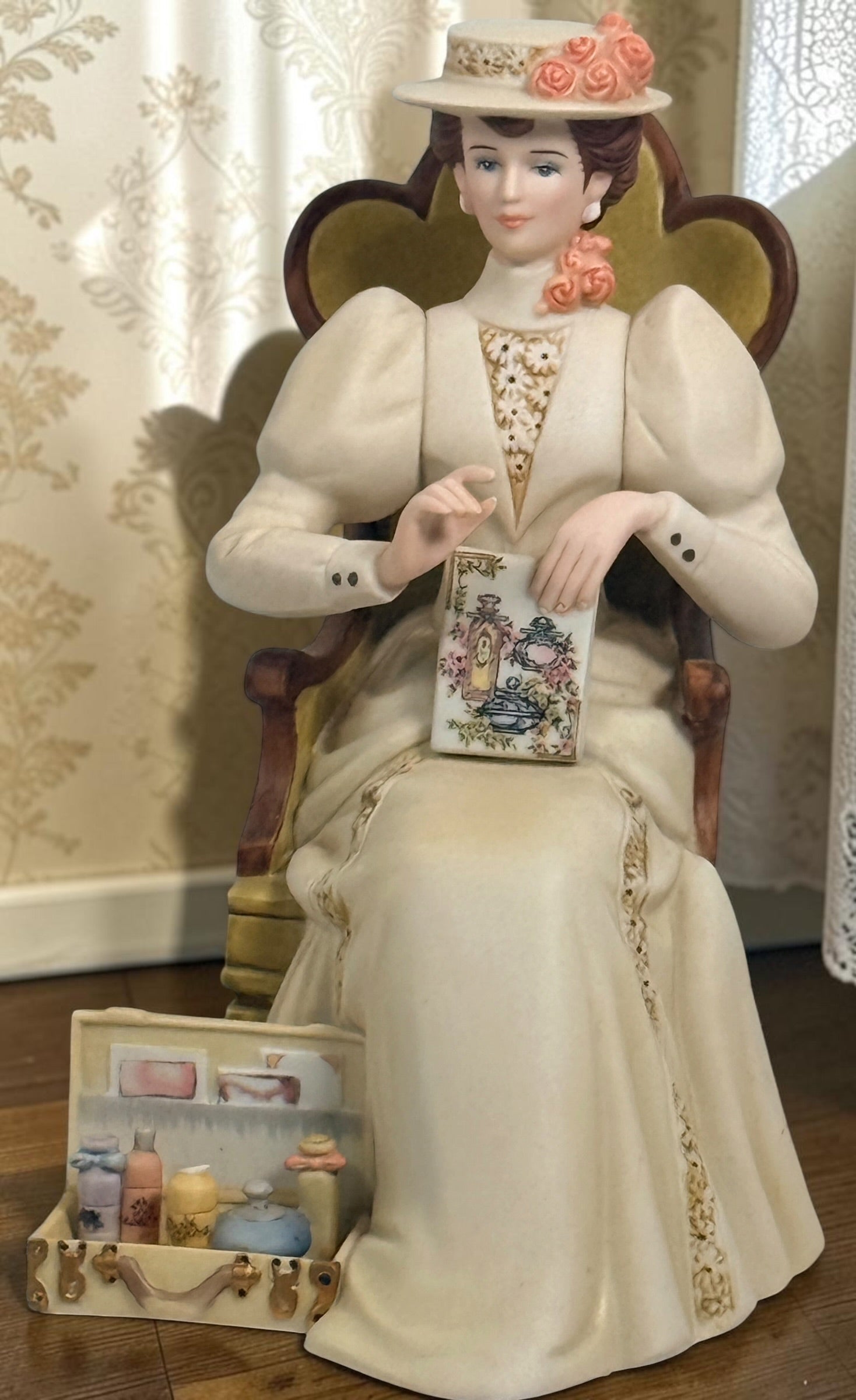 Official Avon Mrs. Albee Award figurine from 2011–2012 featuring Victorian styling, miniature cosmetics accessories, and bilingual commemorative inscription.