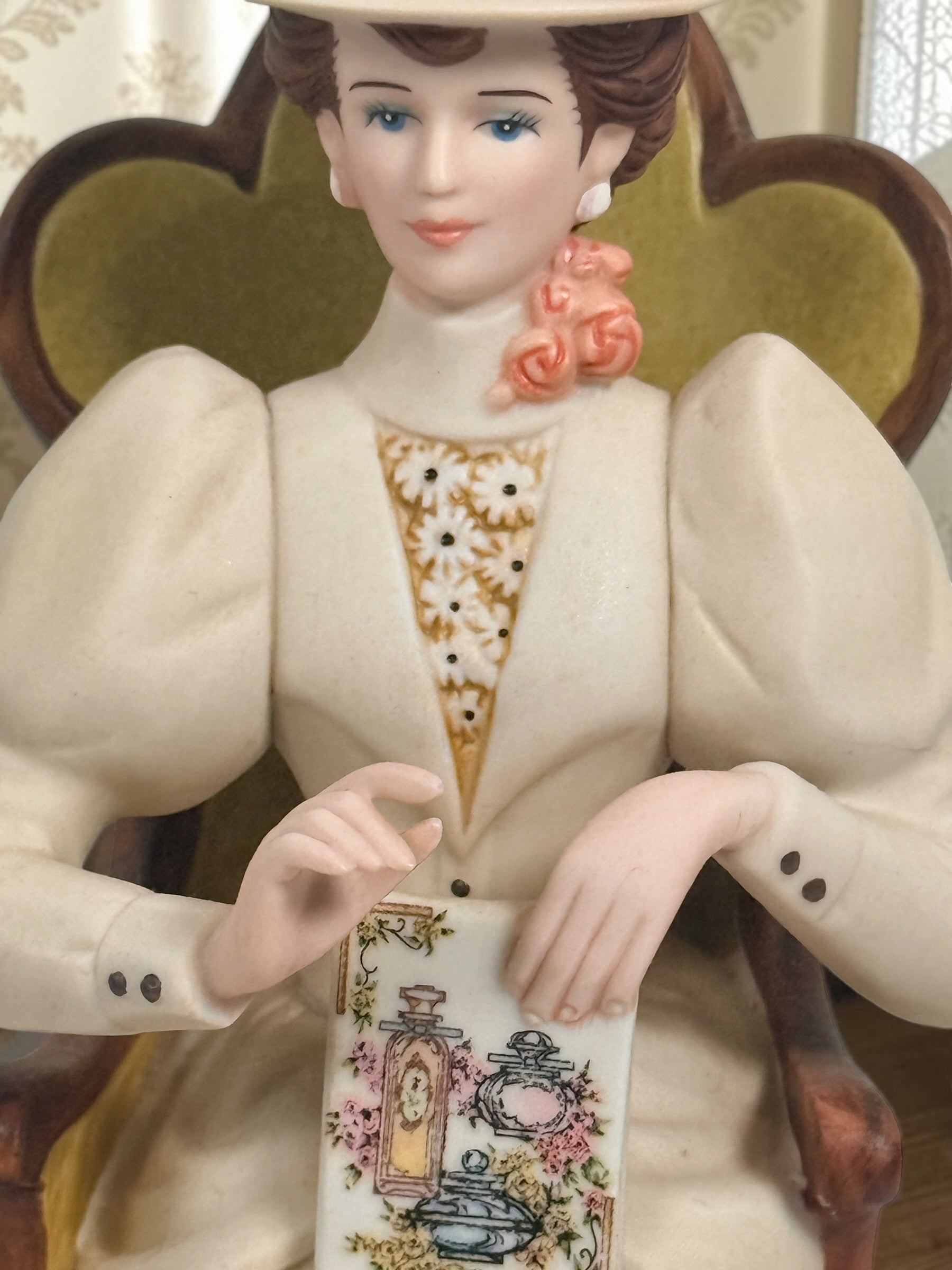 Official Avon Mrs. Albee Award figurine from 2011–2012 featuring Victorian styling, miniature cosmetics accessories, and bilingual commemorative inscription.