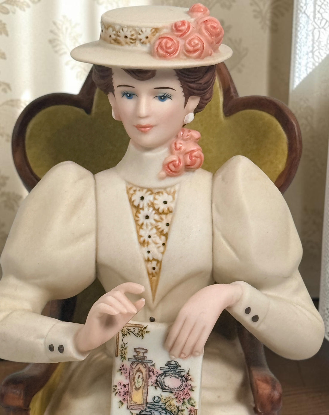 Official Avon Mrs. Albee Award figurine from 2011–2012 featuring Victorian styling, miniature cosmetics accessories, and bilingual commemorative inscription.