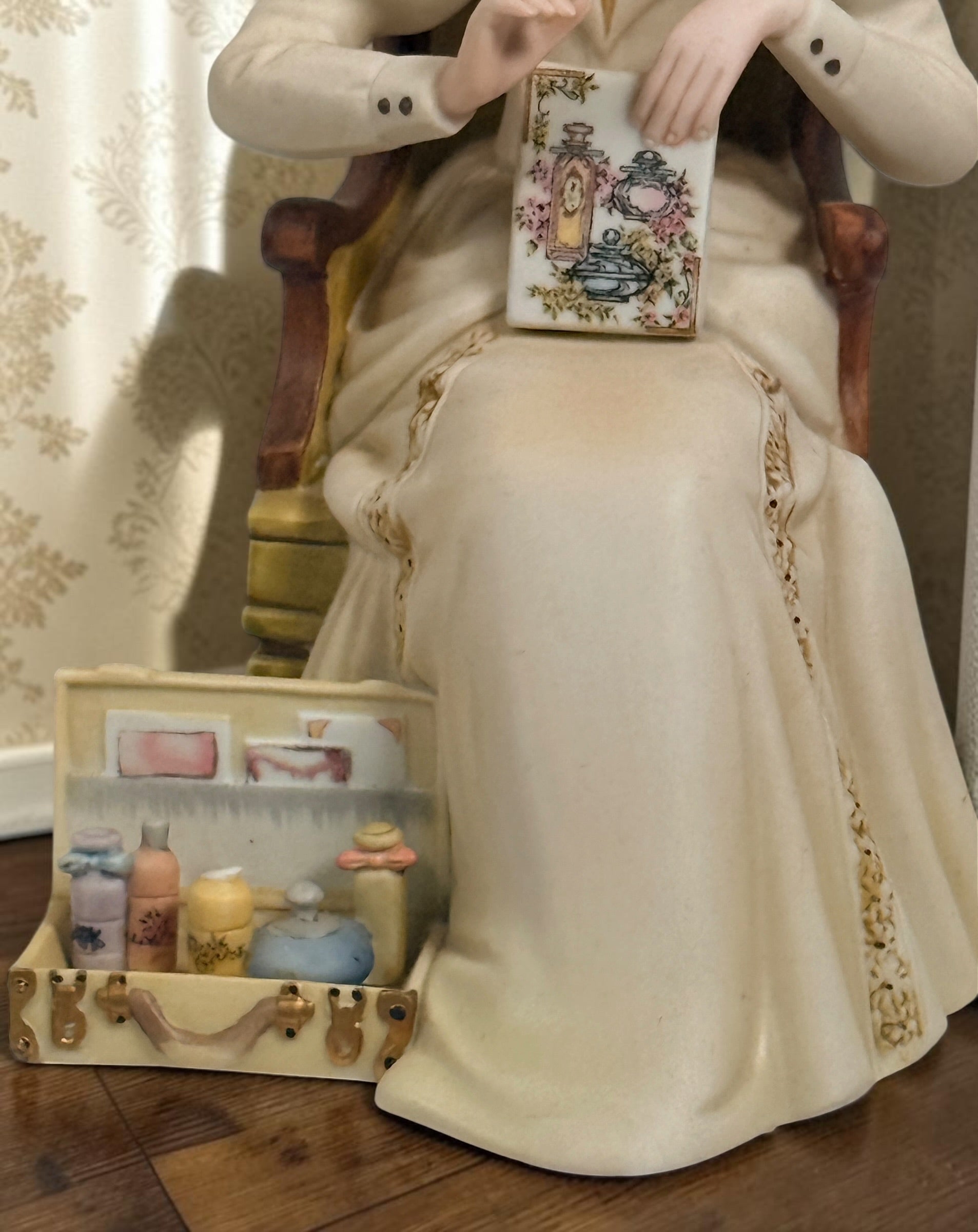 Official Avon Mrs. Albee Award figurine from 2011–2012 featuring Victorian styling, miniature cosmetics accessories, and bilingual commemorative inscription.