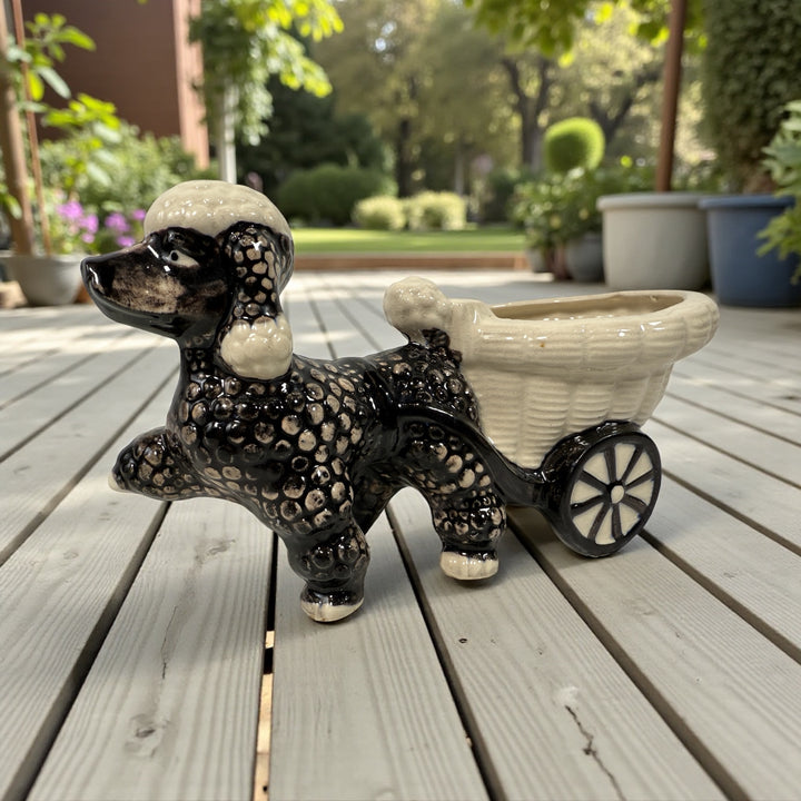 Vintage 1950s ceramic poodle planter with cart, hand-decorated black and cream glaze. Mid-century novelty décor in good condition.