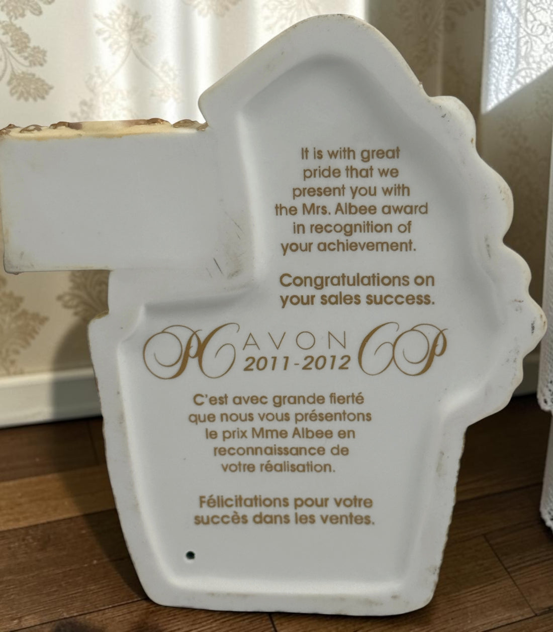 Official Avon Mrs. Albee Award figurine from 2011–2012 featuring Victorian styling, miniature cosmetics accessories, and bilingual commemorative inscription.