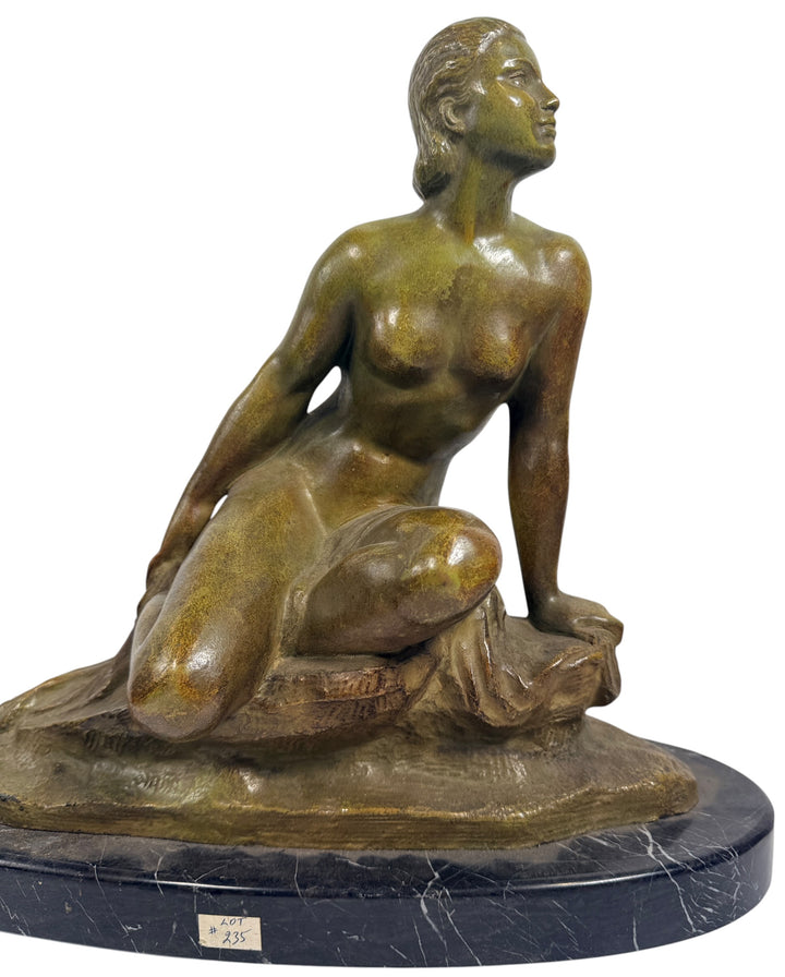 Art Deco seated nude sculpture attributed to Ugo Cipriani, featuring a green-bronze patina and black marble base. Elegant European decorative piece from the 1920s–1930s.