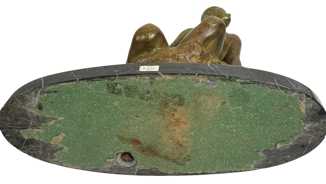 Art Deco seated nude sculpture attributed to Ugo Cipriani, featuring a green-bronze patina and black marble base. Elegant European decorative piece from the 1920s–1930s.