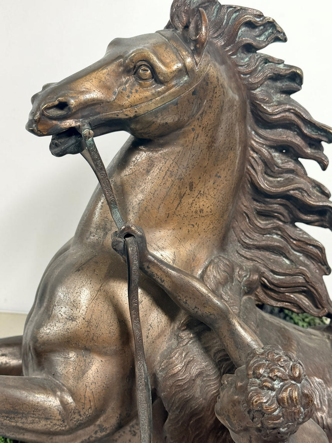 Antique Horse of Marly sculpture after Guillaume Coustou in patinated spelter, circa 1880–1910. Signed “Coustou,” featuring a dramatic horse tamer composition.