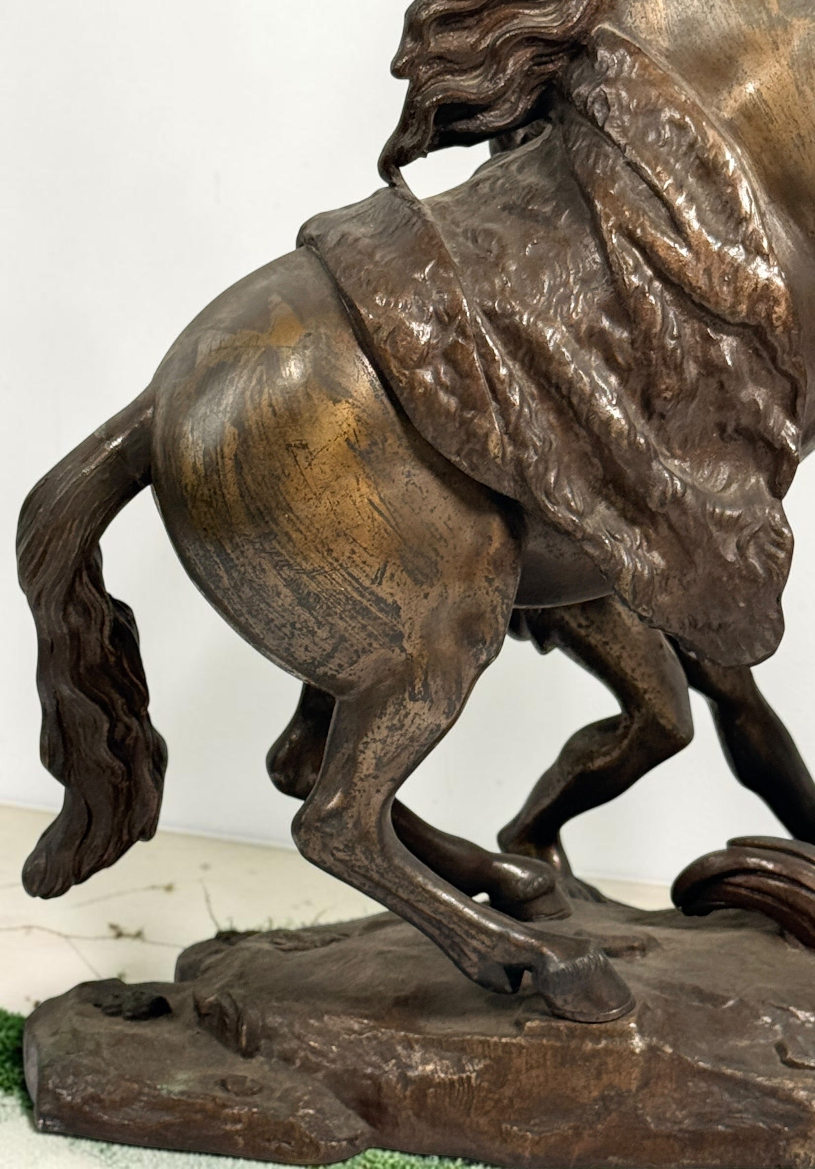 Antique Horse of Marly sculpture after Guillaume Coustou in patinated spelter, circa 1880–1910. Signed “Coustou,” featuring a dramatic horse tamer composition.