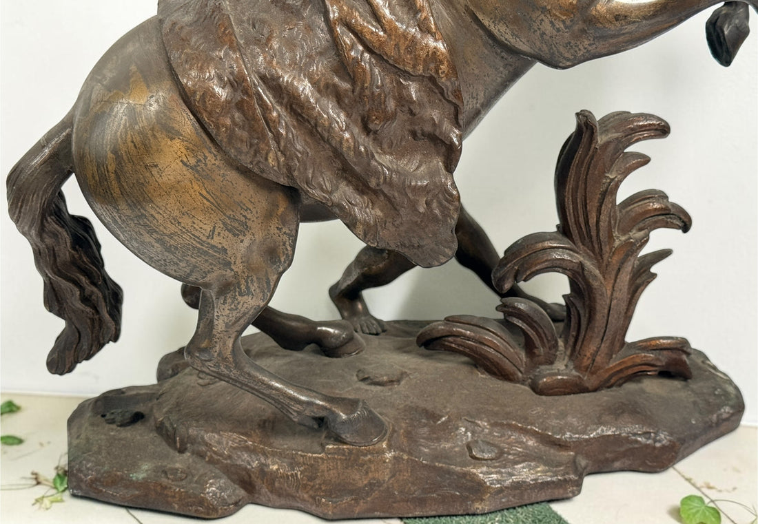 Antique Horse of Marly sculpture after Guillaume Coustou in patinated spelter, circa 1880–1910. Signed “Coustou,” featuring a dramatic horse tamer composition.