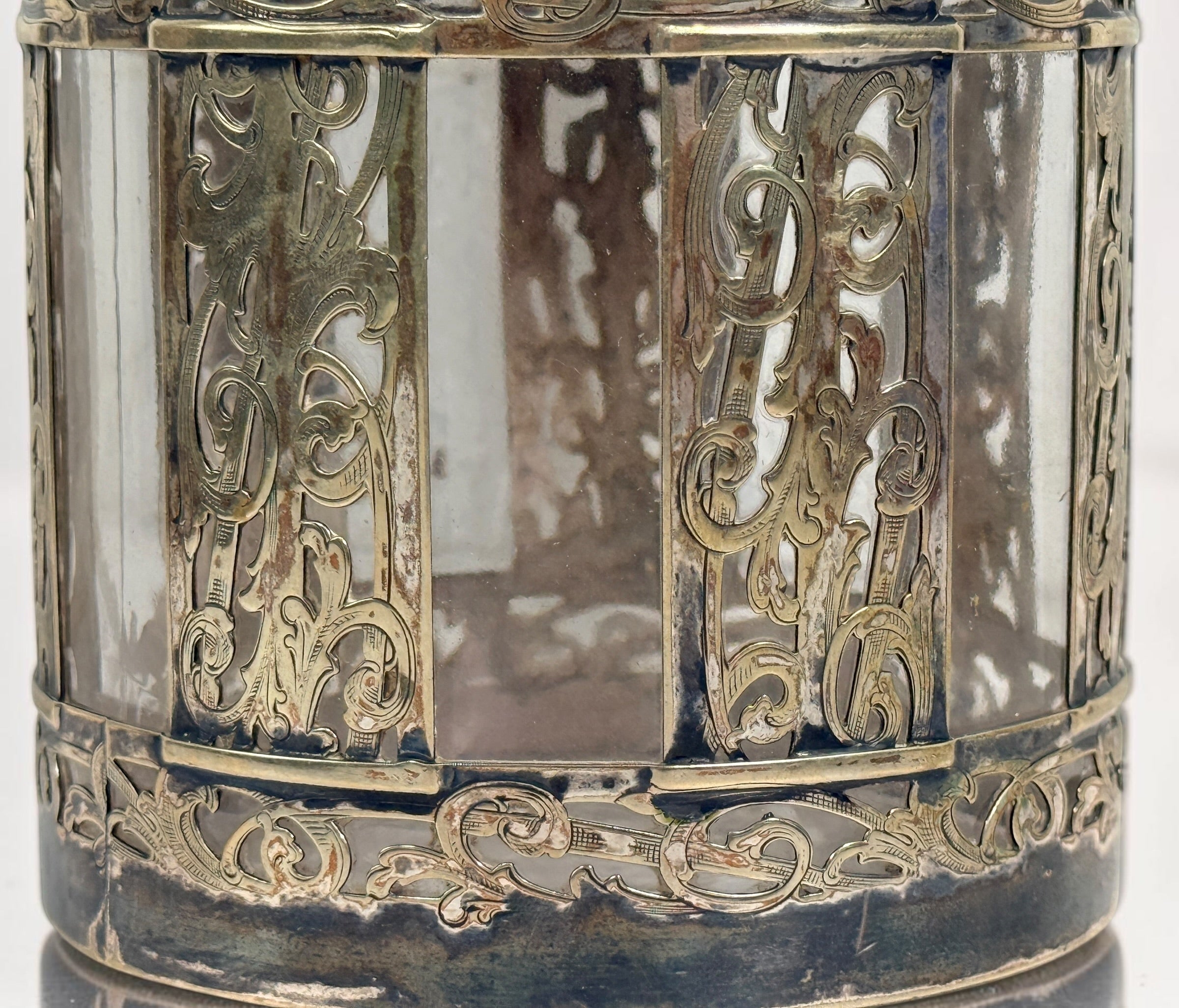 Antique Victorian glass tobacco humidor with ornate German silver overlay, engraved floral motifs, and domed lid. Elegant late-19th-century decorative storage jar.