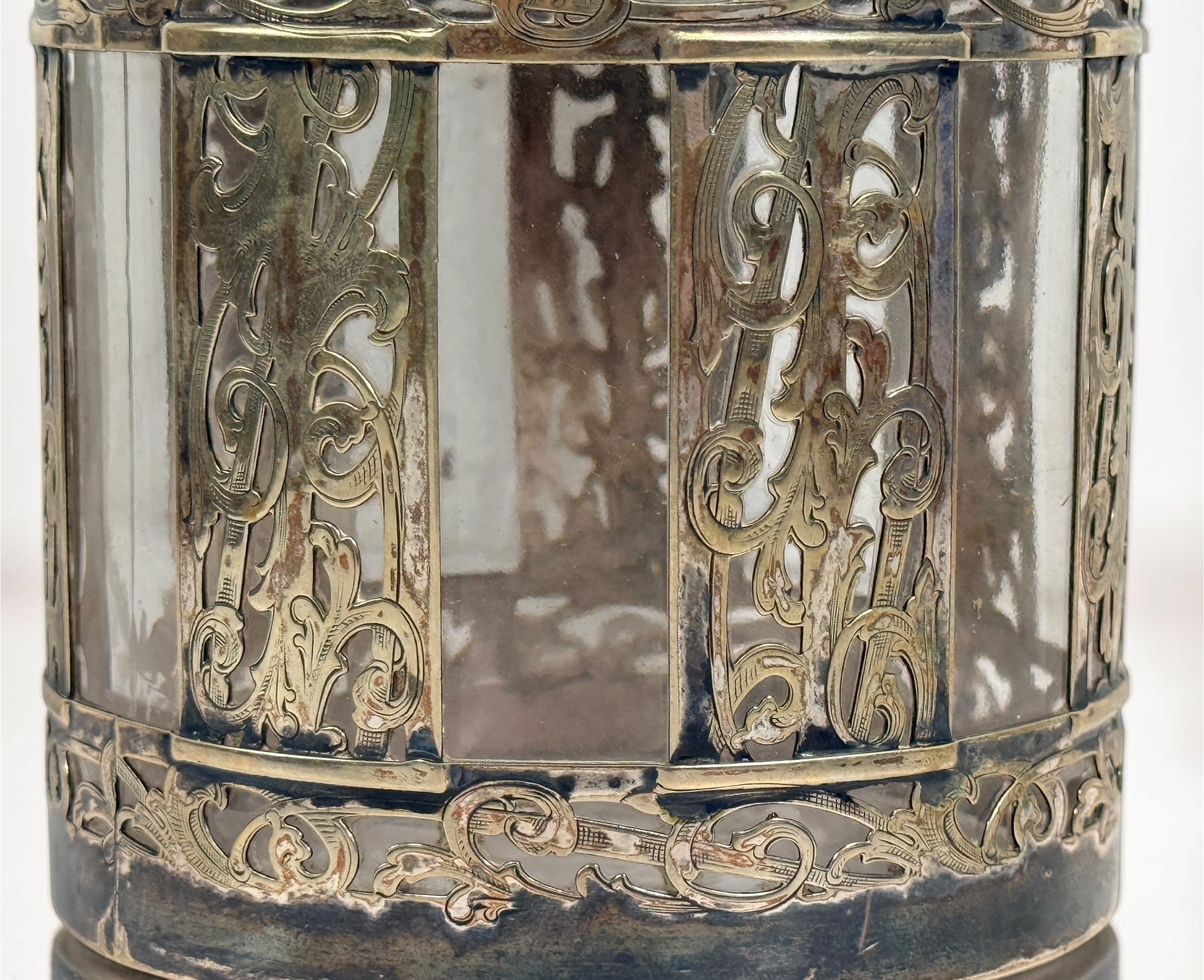 Antique Victorian glass tobacco humidor with ornate German silver overlay, engraved floral motifs, and domed lid. Elegant late-19th-century decorative storage jar.