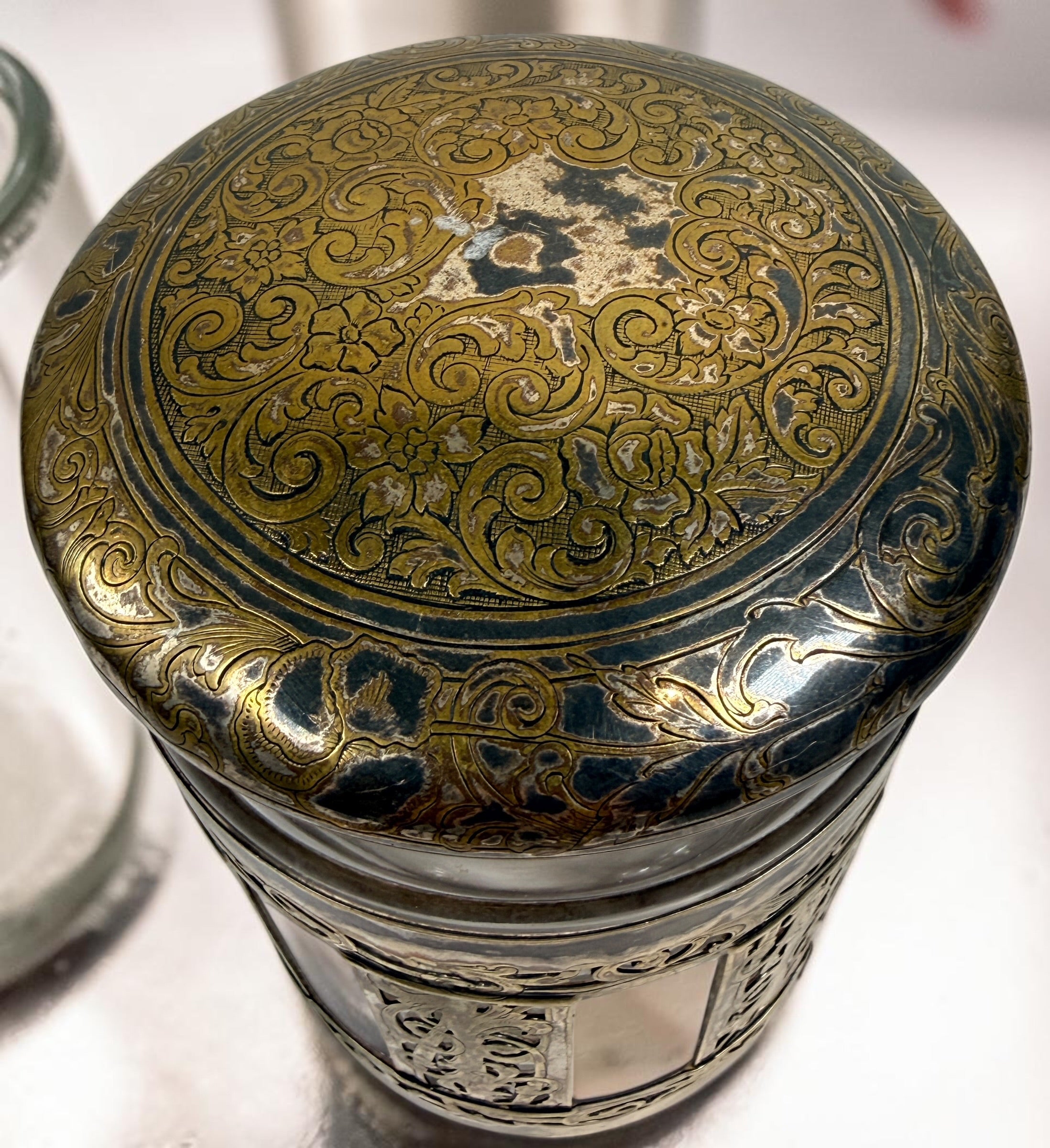 Antique Victorian glass tobacco humidor with ornate German silver overlay, engraved floral motifs, and domed lid. Elegant late-19th-century decorative storage jar.