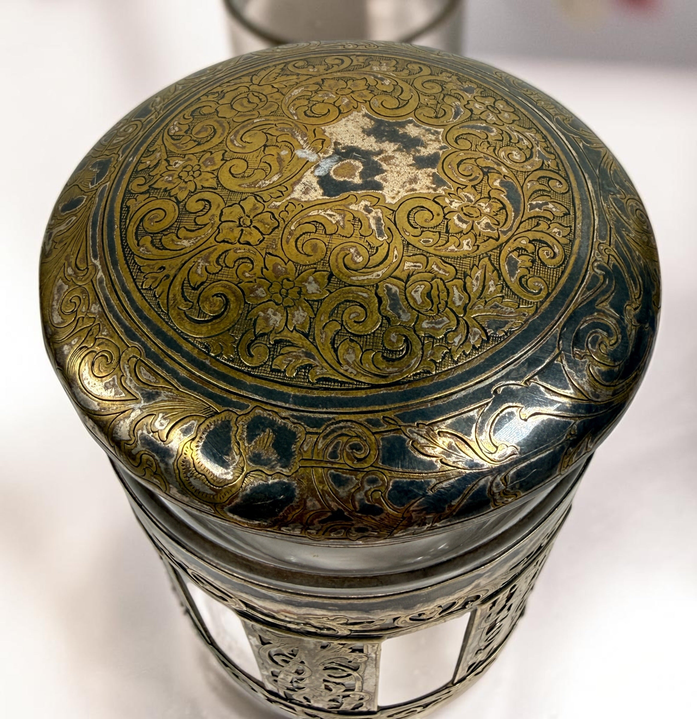 Antique Victorian glass tobacco humidor with ornate German silver overlay, engraved floral motifs, and domed lid. Elegant late-19th-century decorative storage jar.