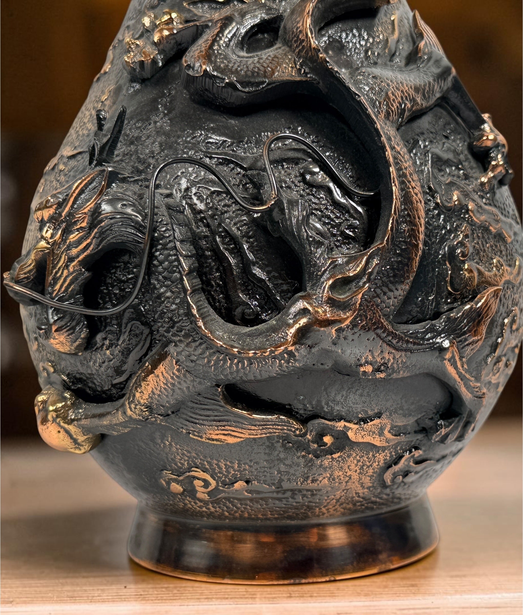 Japanese Meiji-style dragon vase in cast metal with dark bronze finish. Features high-relief dragon decoration, textured surface, and stands 12 inches tall.