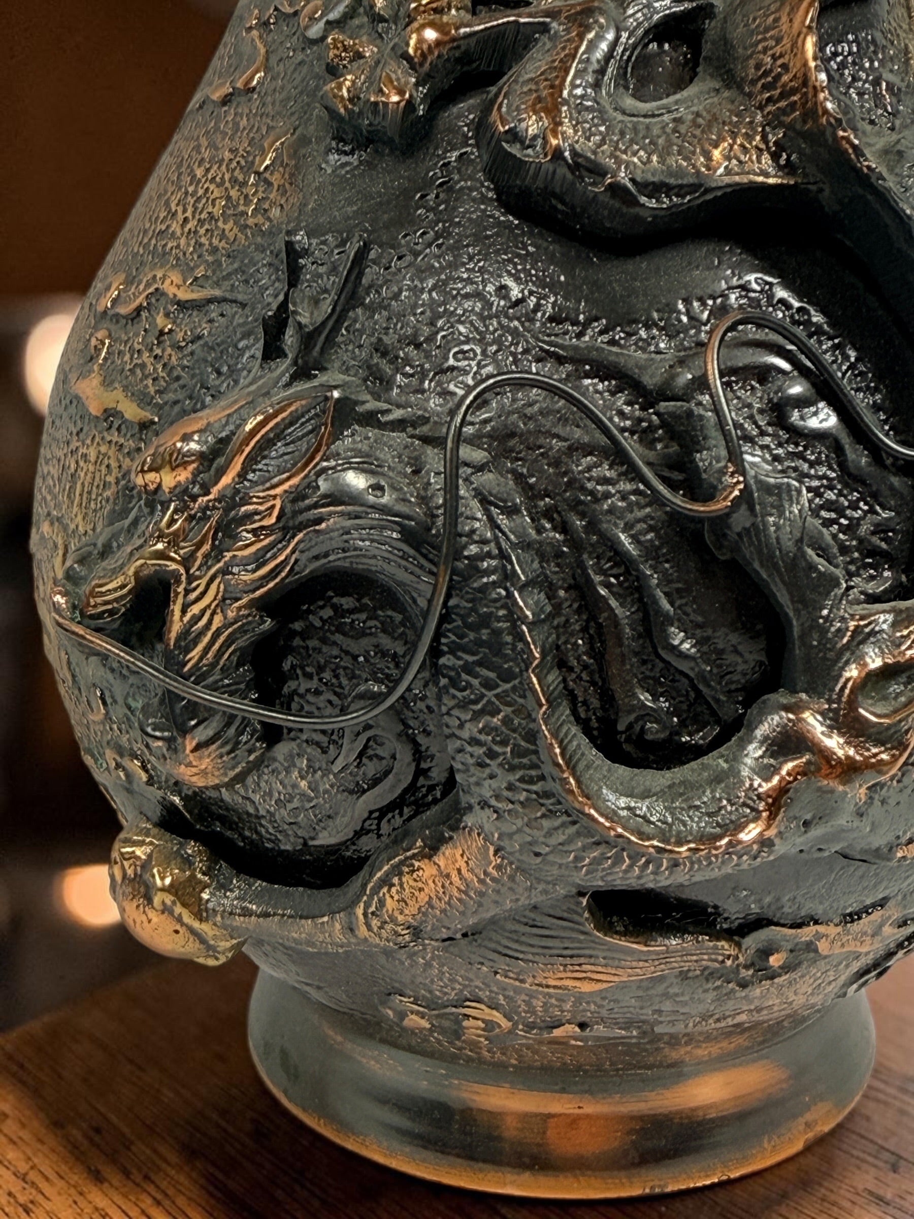 Japanese Meiji-style dragon vase in cast metal with dark bronze finish. Features high-relief dragon decoration, textured surface, and stands 12 inches tall.