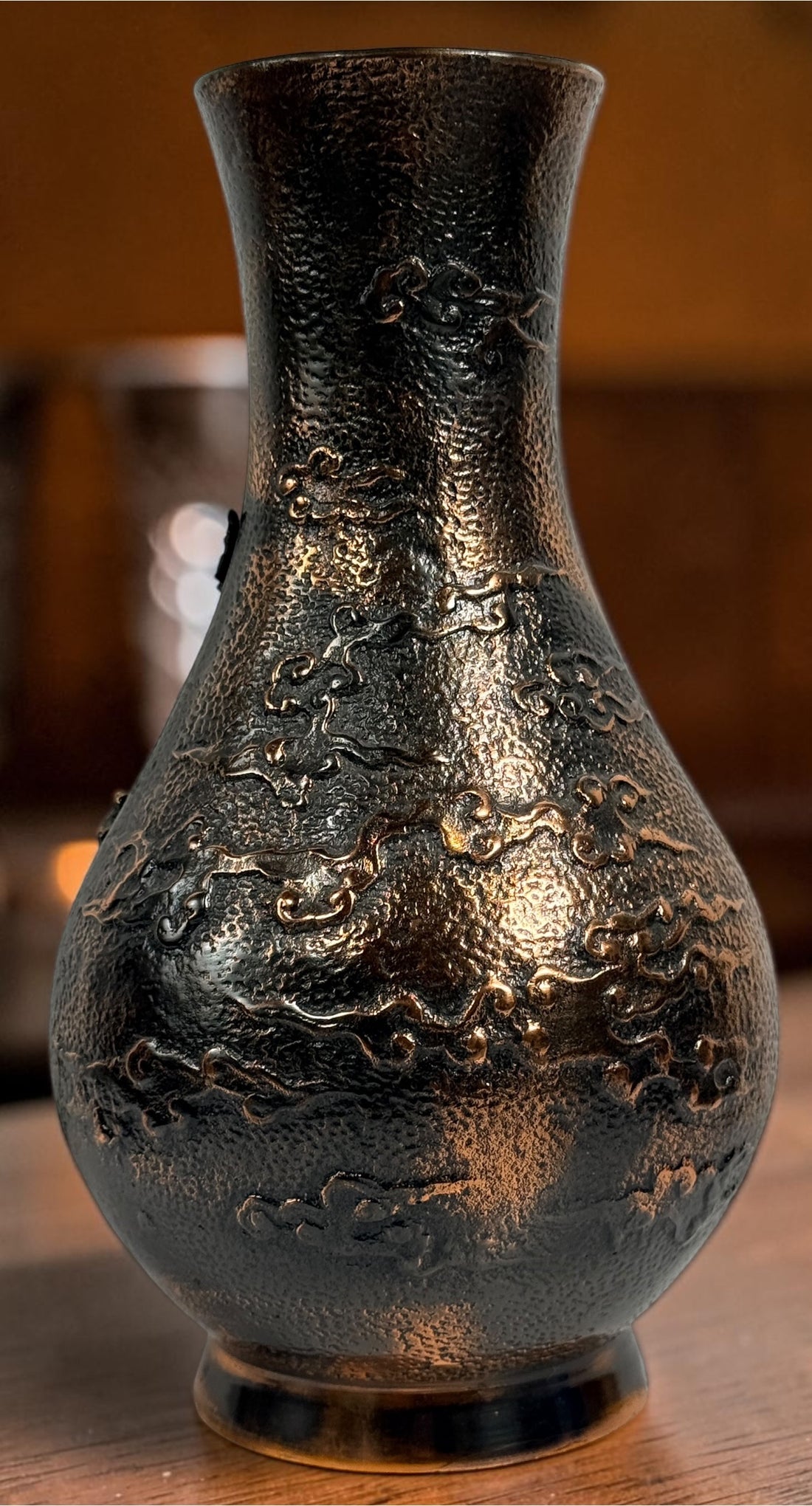 Japanese Meiji-style dragon vase in cast metal with dark bronze finish. Features high-relief dragon decoration, textured surface, and stands 12 inches tall.