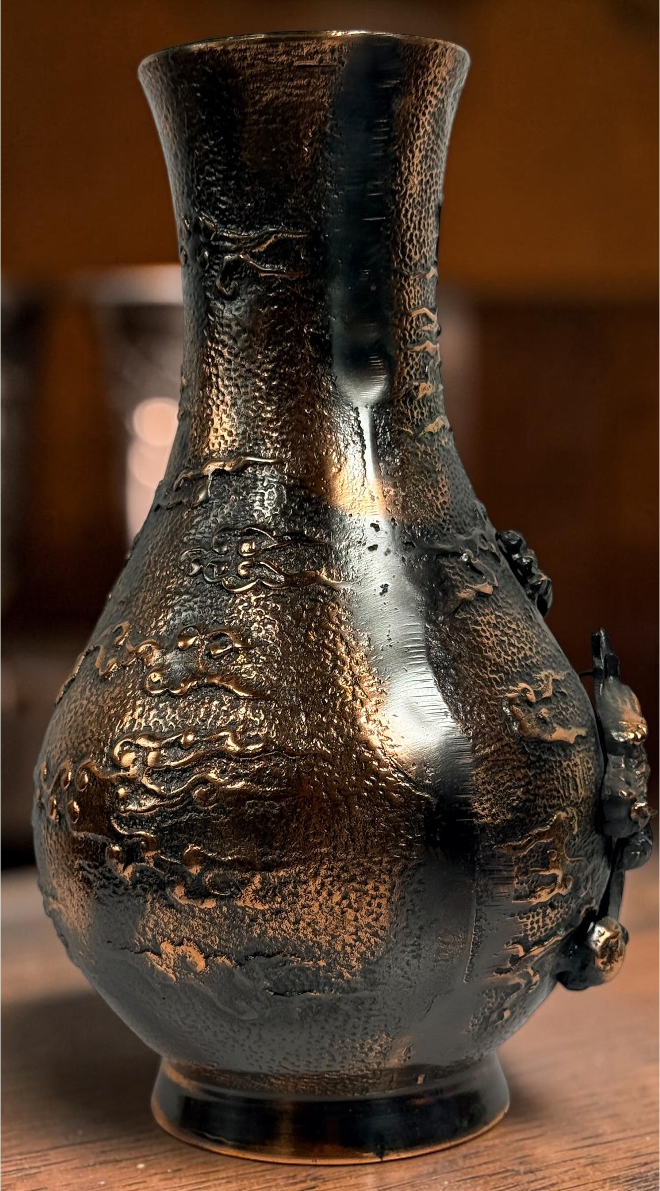 Japanese Meiji-style dragon vase in cast metal with dark bronze finish. Features high-relief dragon decoration, textured surface, and stands 12 inches tall.