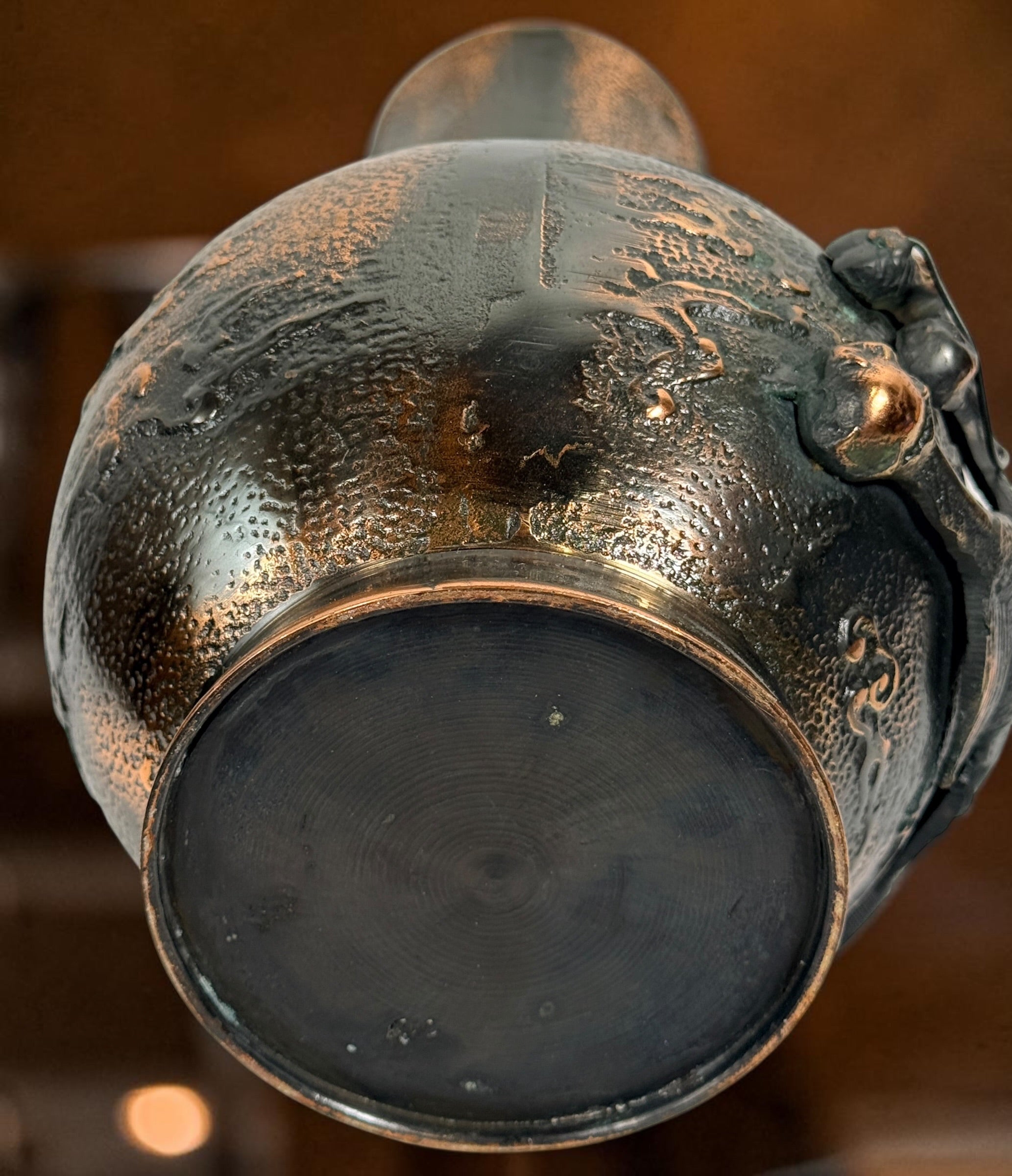 Japanese Meiji-style dragon vase in cast metal with dark bronze finish. Features high-relief dragon decoration, textured surface, and stands 12 inches tall.