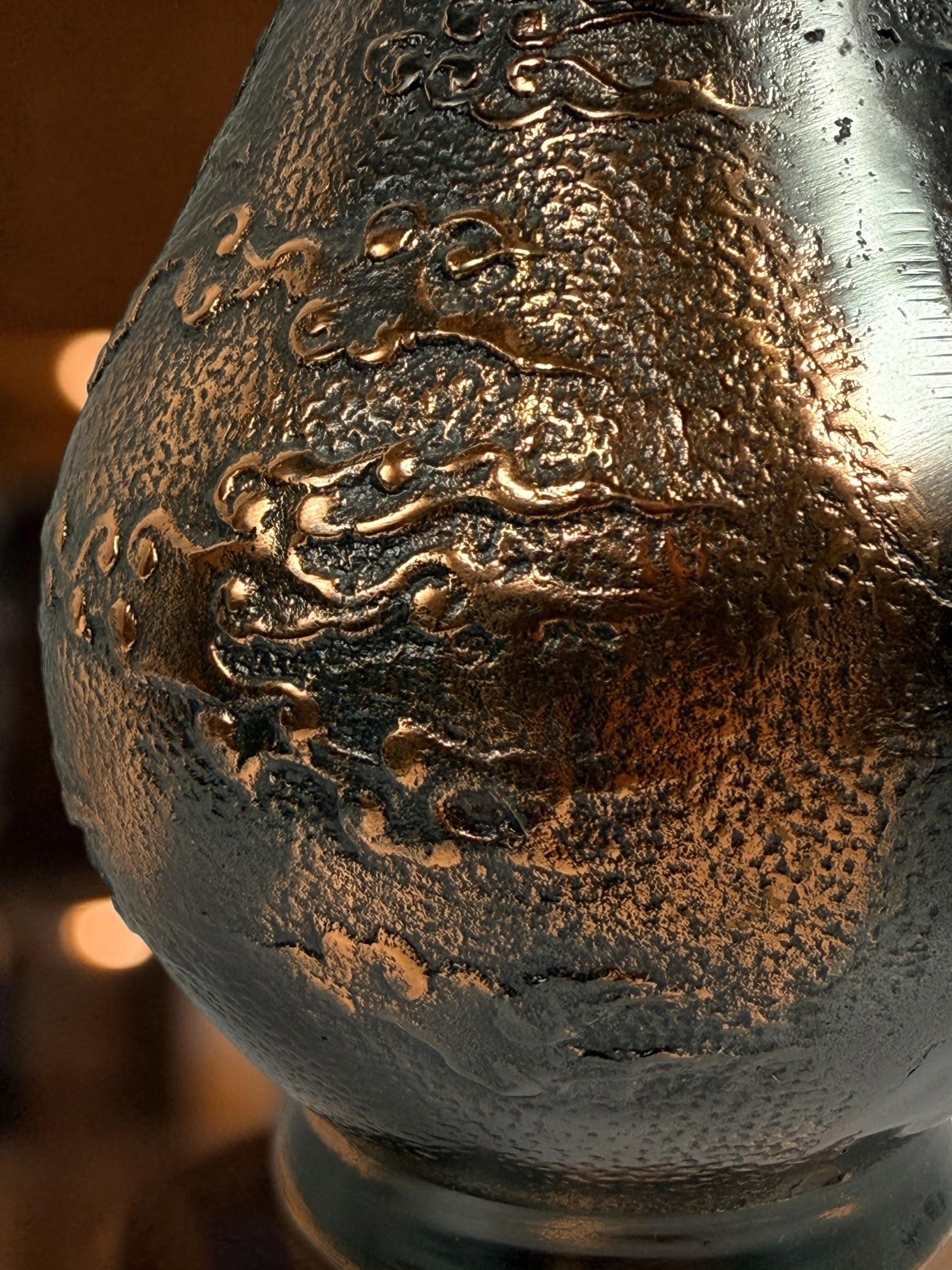 Japanese Meiji-style dragon vase in cast metal with dark bronze finish. Features high-relief dragon decoration, textured surface, and stands 12 inches tall.
