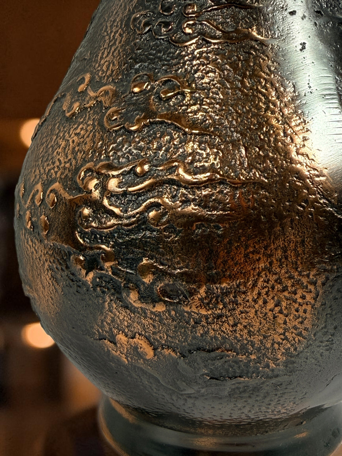Japanese Meiji-style dragon vase in cast metal with dark bronze finish. Features high-relief dragon decoration, textured surface, and stands 12 inches tall.